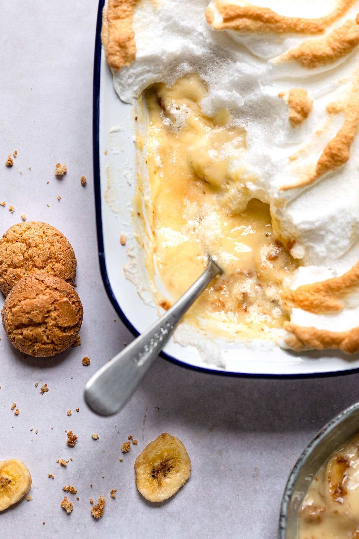 Pan of old-fashioned banana pudding with a spoon in it.