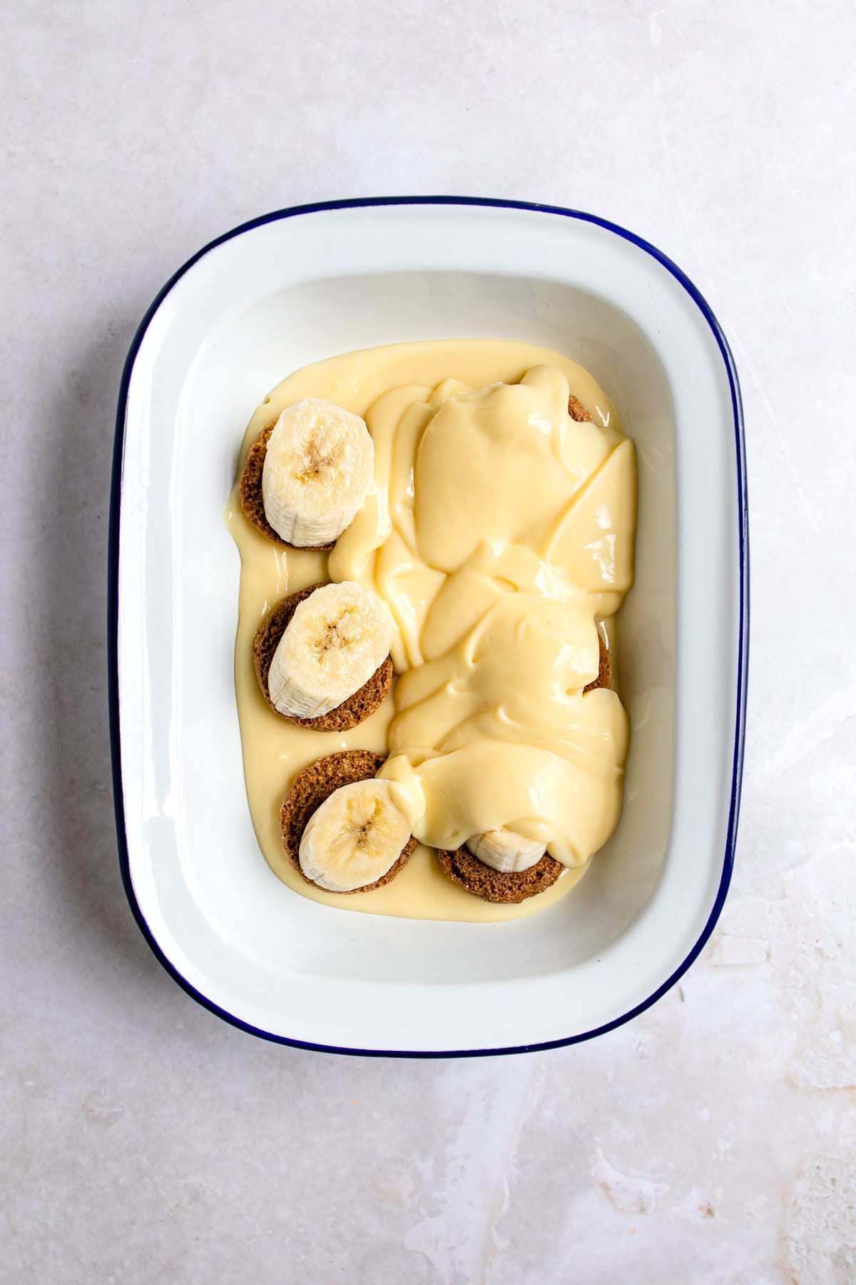 Vanilla pudding over part of the nilla wafers and banana slices. 