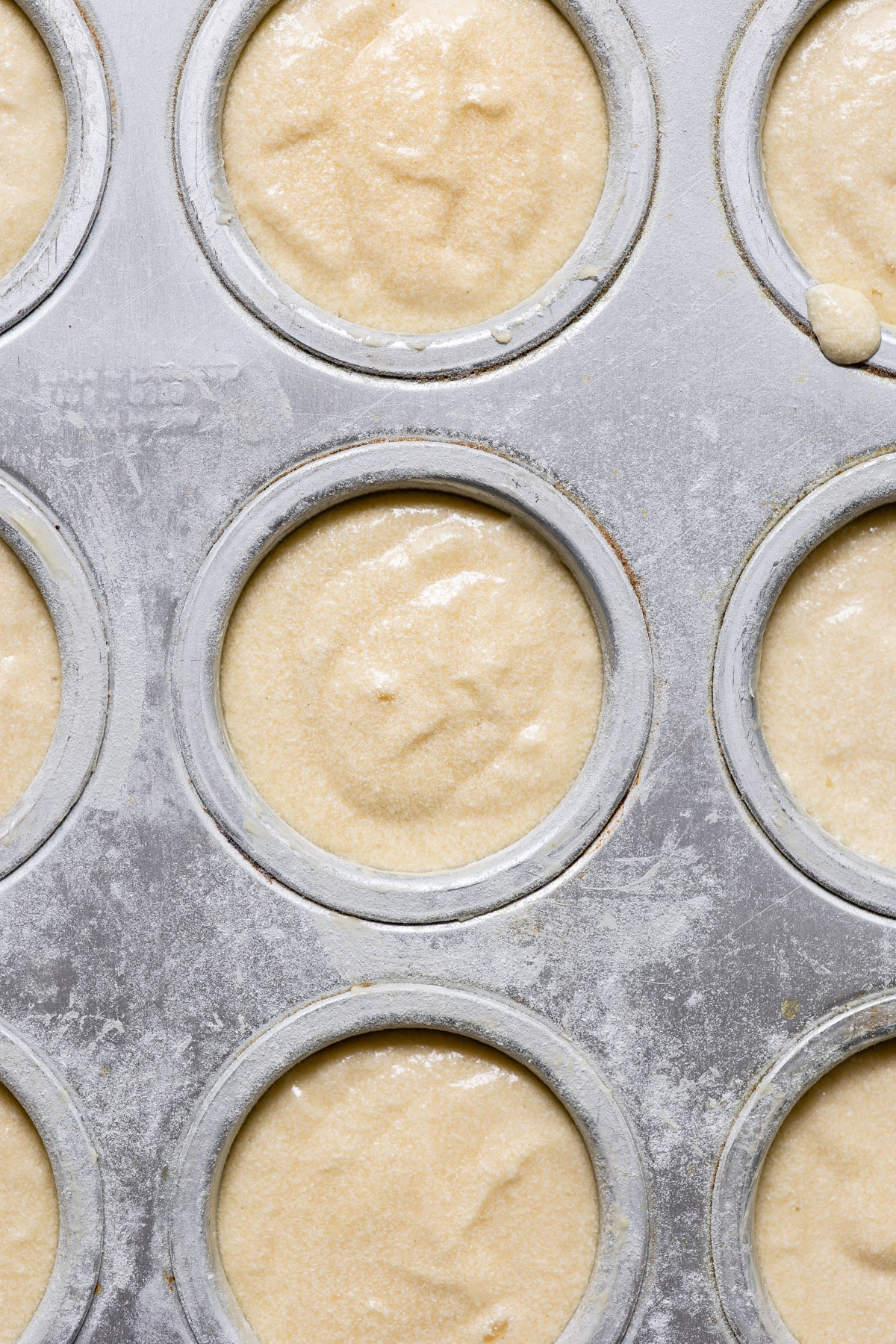 Cupcake batter in a muffin tin.