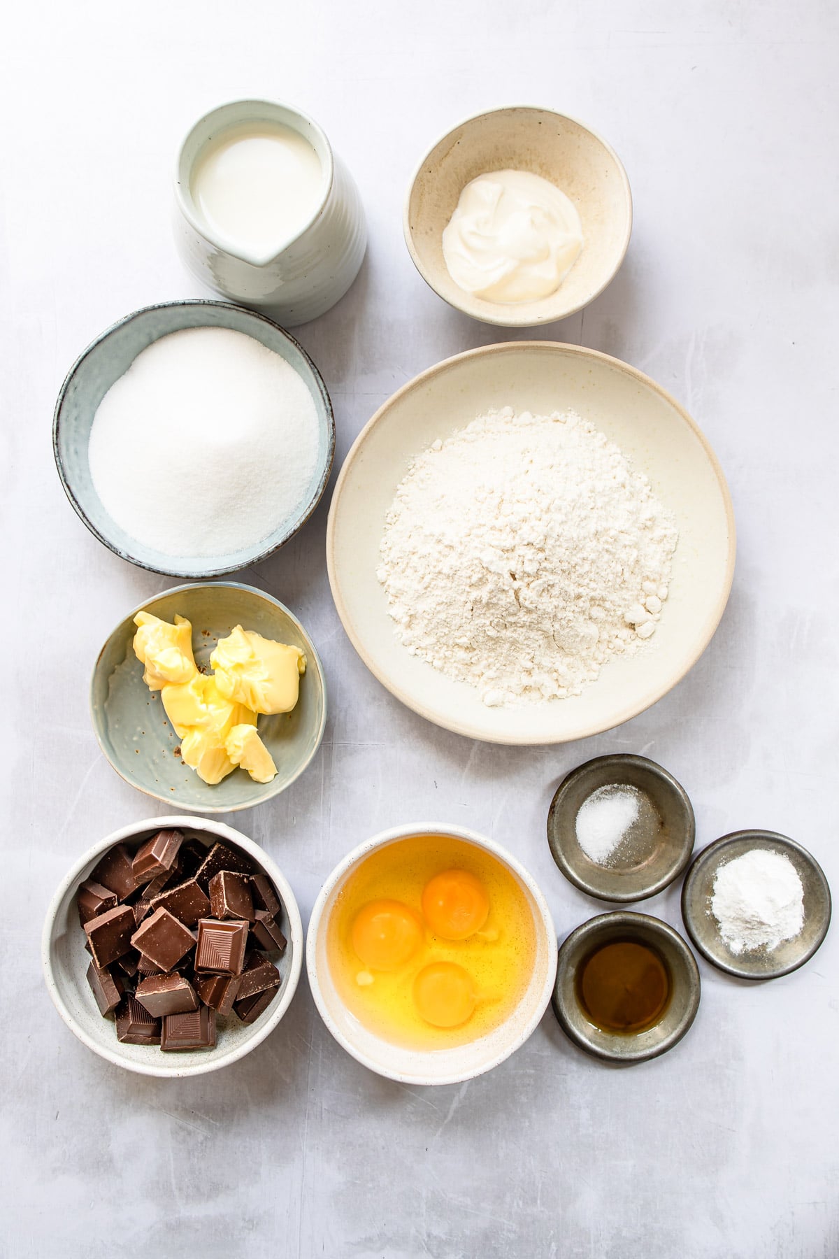 Ingredients for Boston cream pie cupcakes in dishes. 