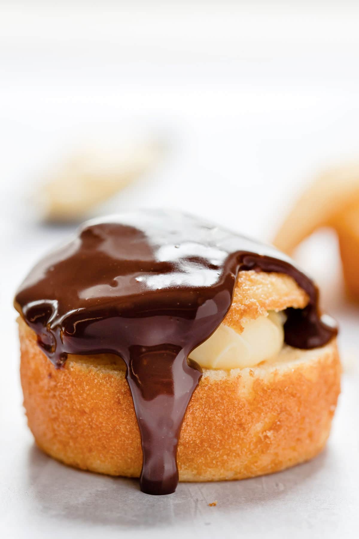 Close up photo of a Boston cream pie cupcake. 