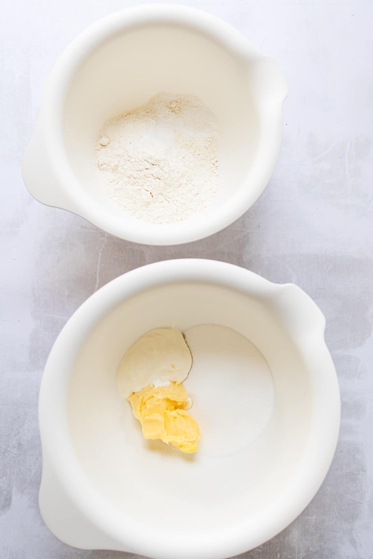 Butter sugar and sour cream in bowls.