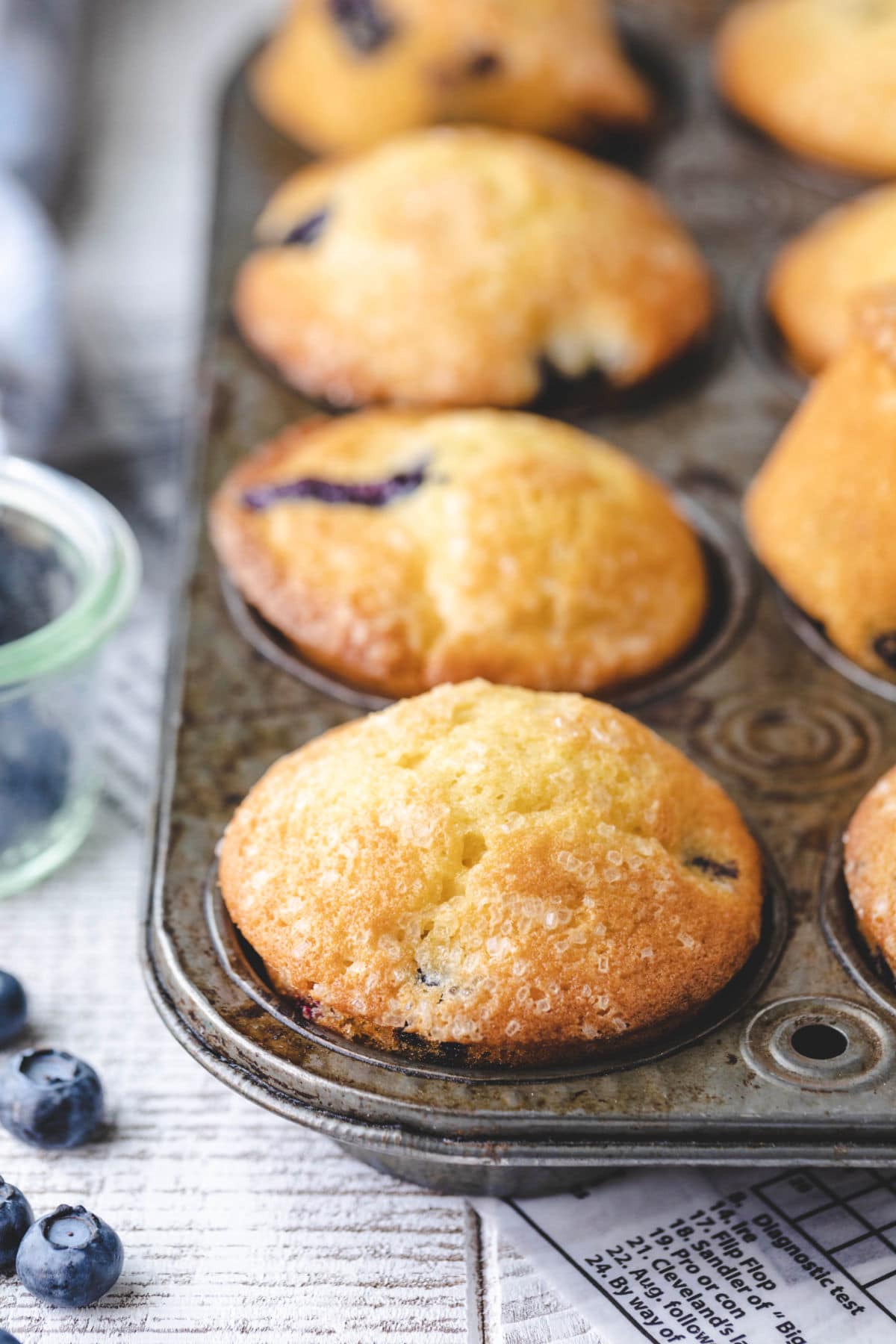 Bakery style blueberry muffins in a vintage muffin tin.