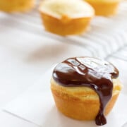 Boston cream pie cupcake on a piece of white parchment paper.