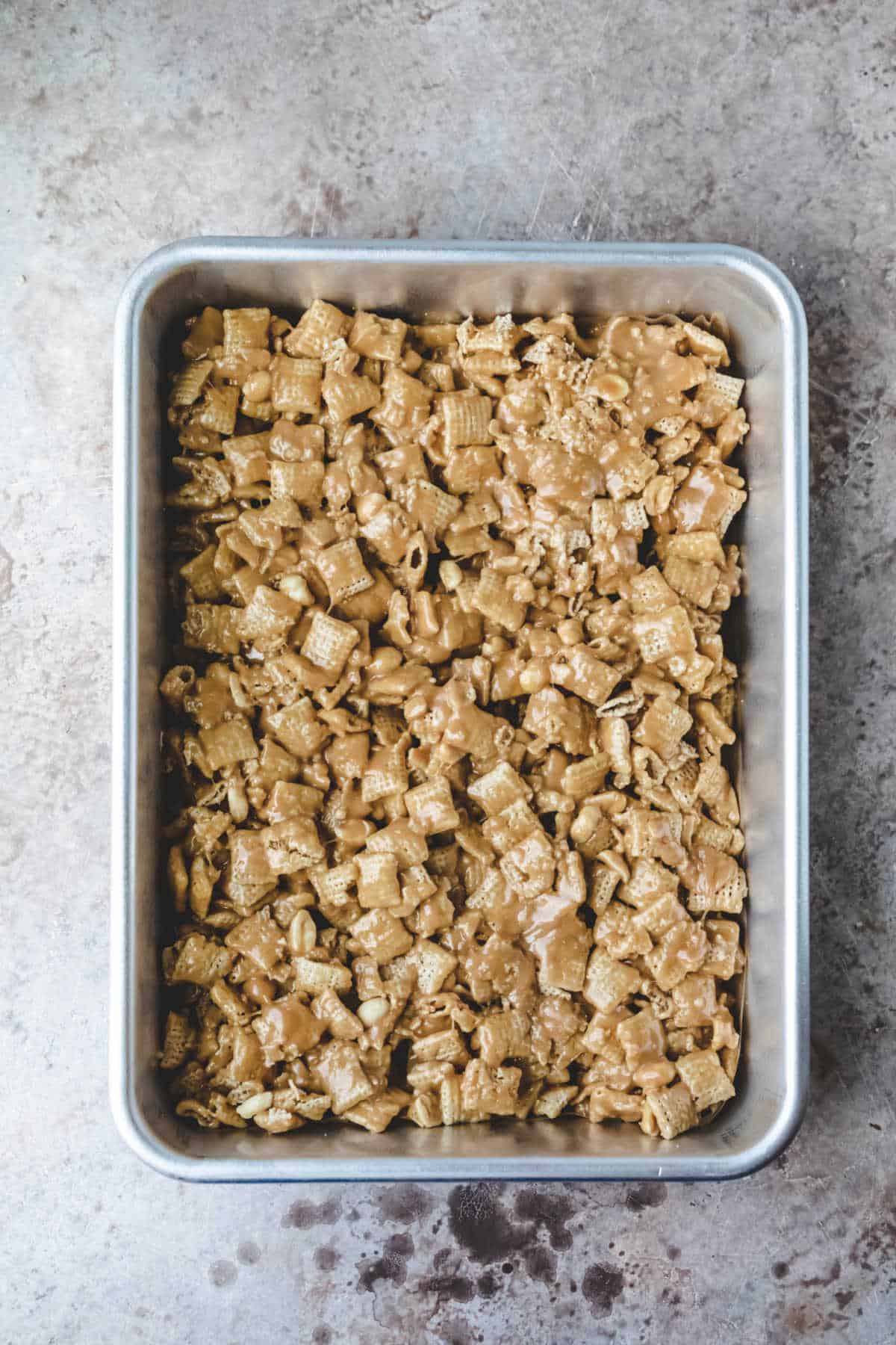 Peanut butter Chex cereal treats in a baking pan.