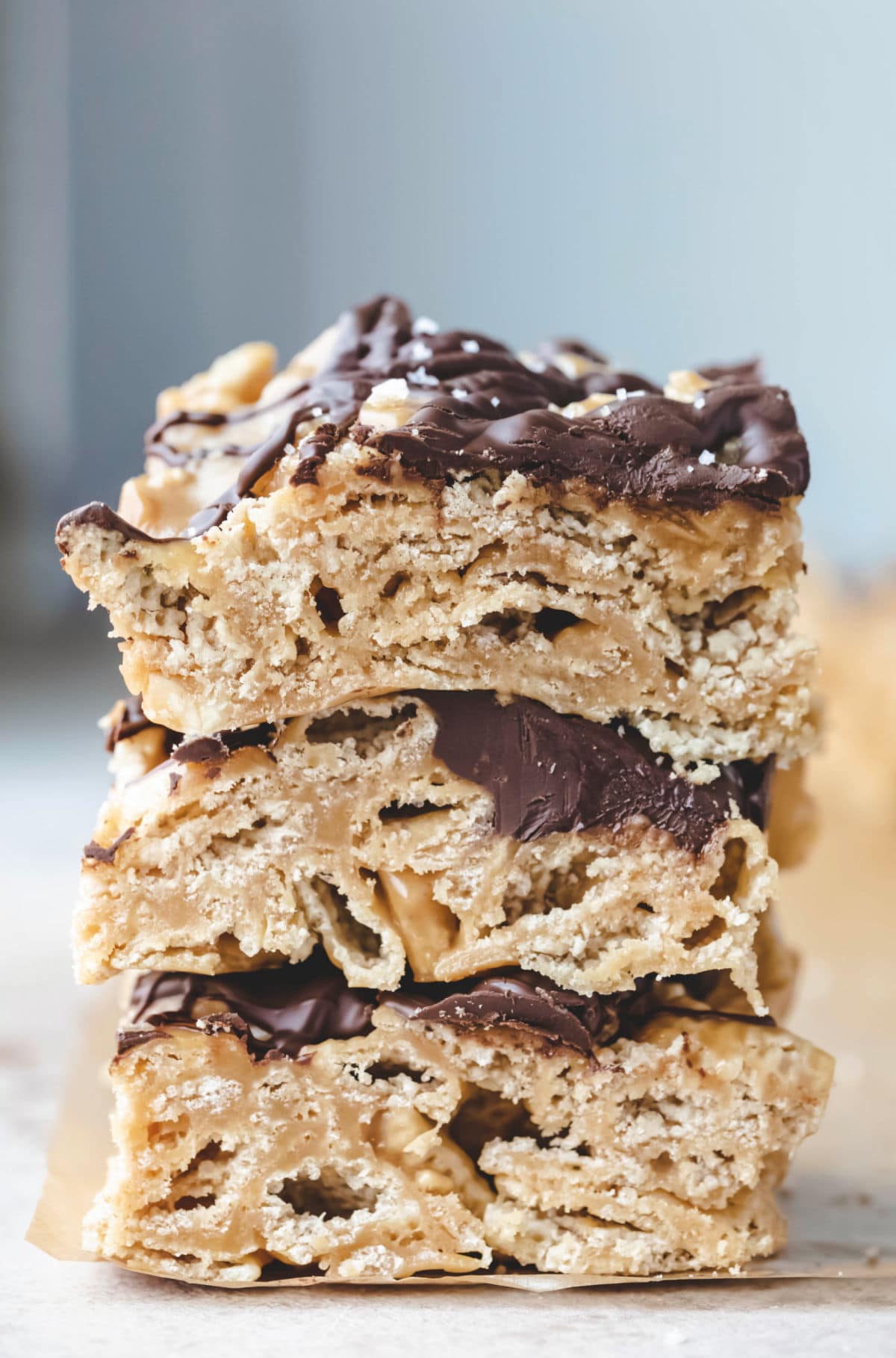 Three chocolate peanut butter chex bars stacked on top of each other. 