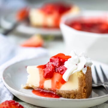 Homemade strawberry topping on a slice of cheesecake.