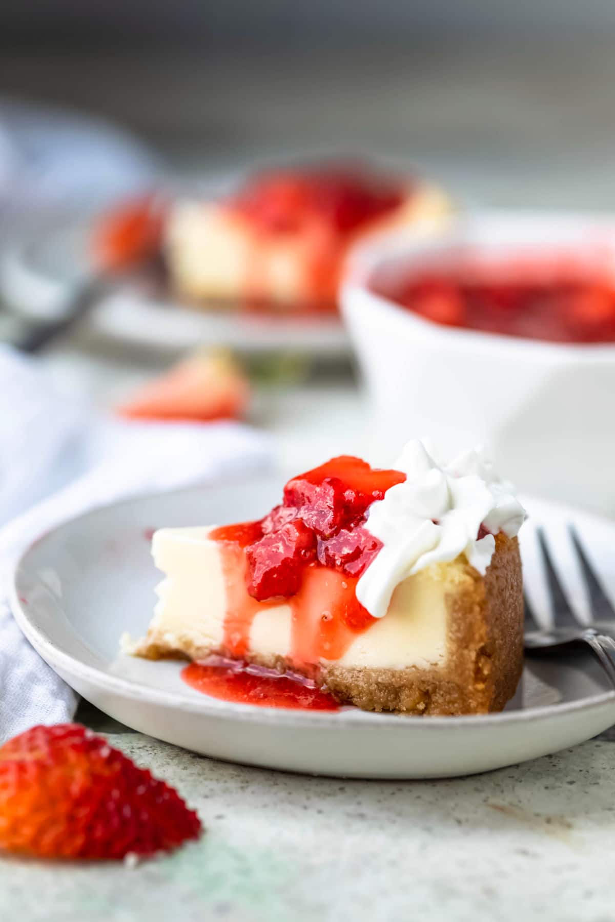 Homemade strawberry topping on a slice of cheesecake.