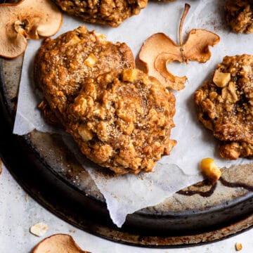 Apple crisp cookies next to pieces of dried apple.