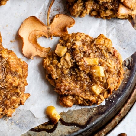 Apple crisp cookies on white parchment paper.