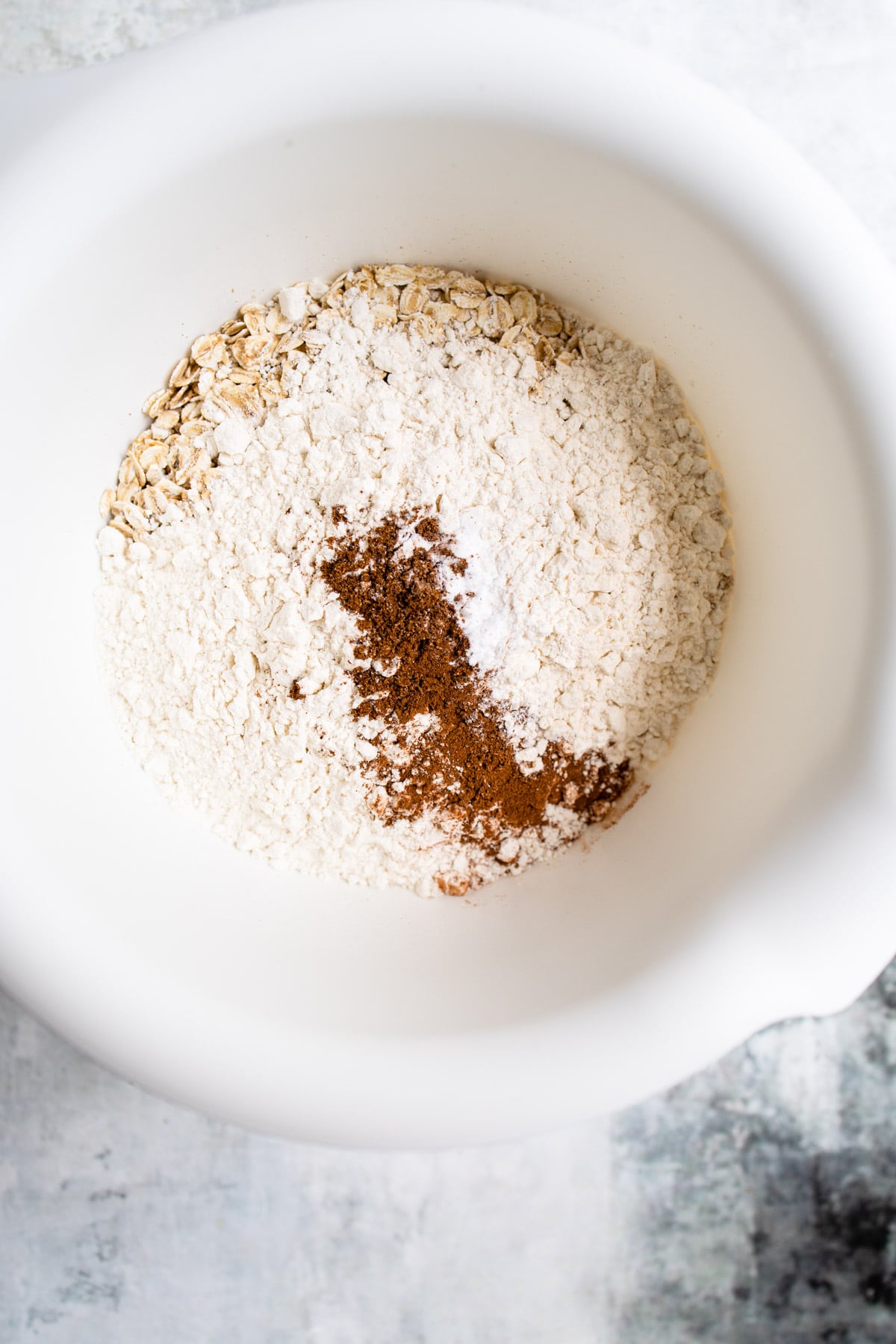 Dry ingredients for apple crisp cookies in a mixing bowl.