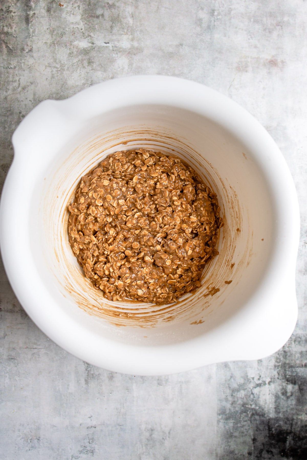 Wet and dry ingredients mixed together in a mixing bowl. 