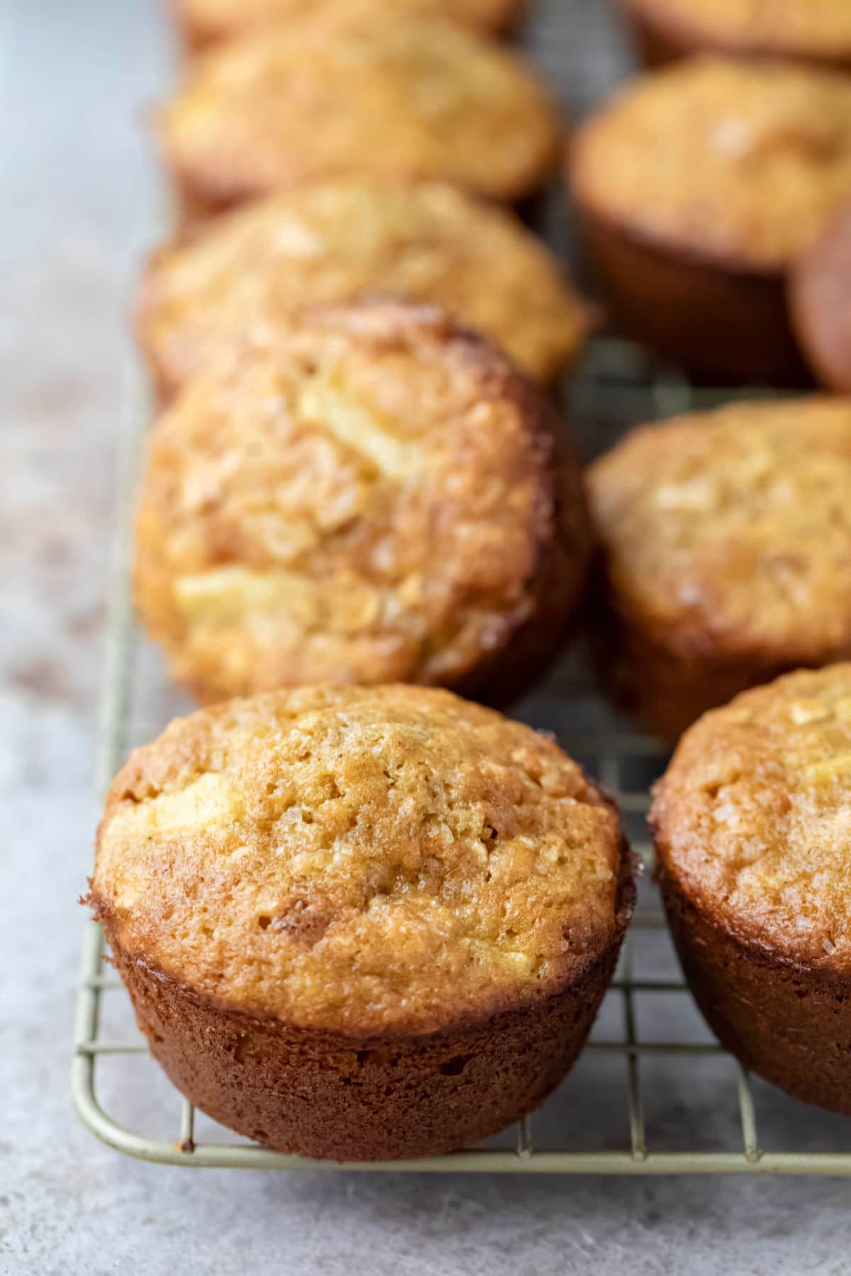 Apple cinnamon oatmeal muffins on a wire cooling rack.