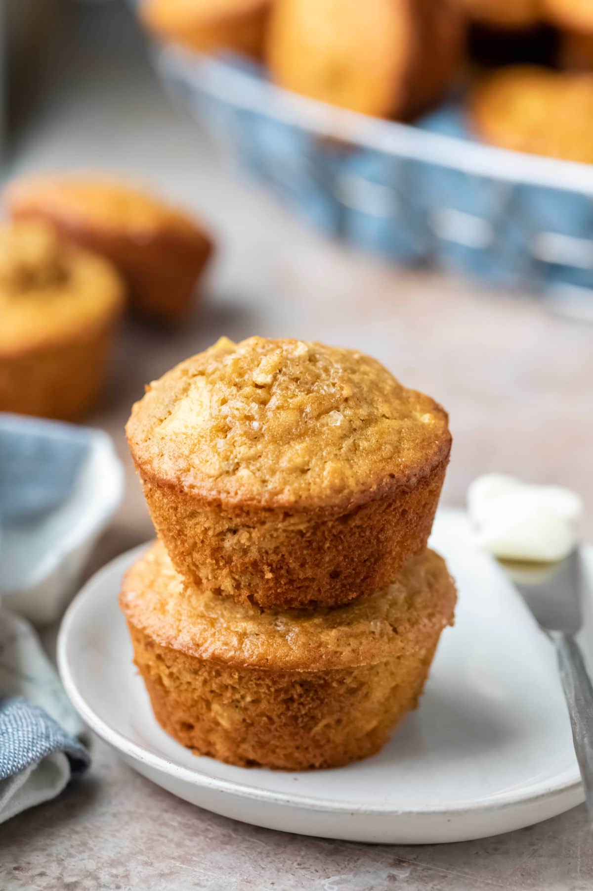 Plate of oatmeal muffins next to a butter knife. 