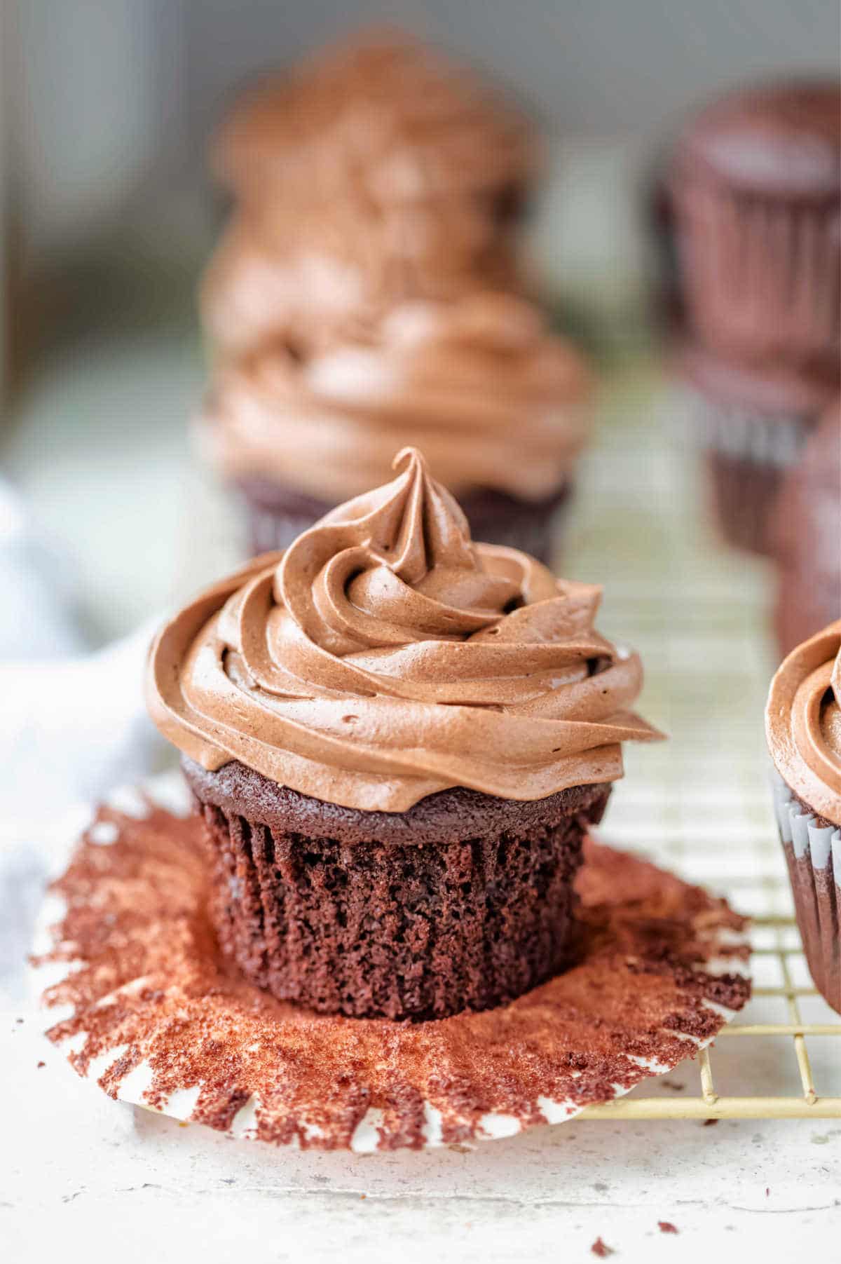 Swirl of chocolate cream cheese frosting on a chocolate cupcake.