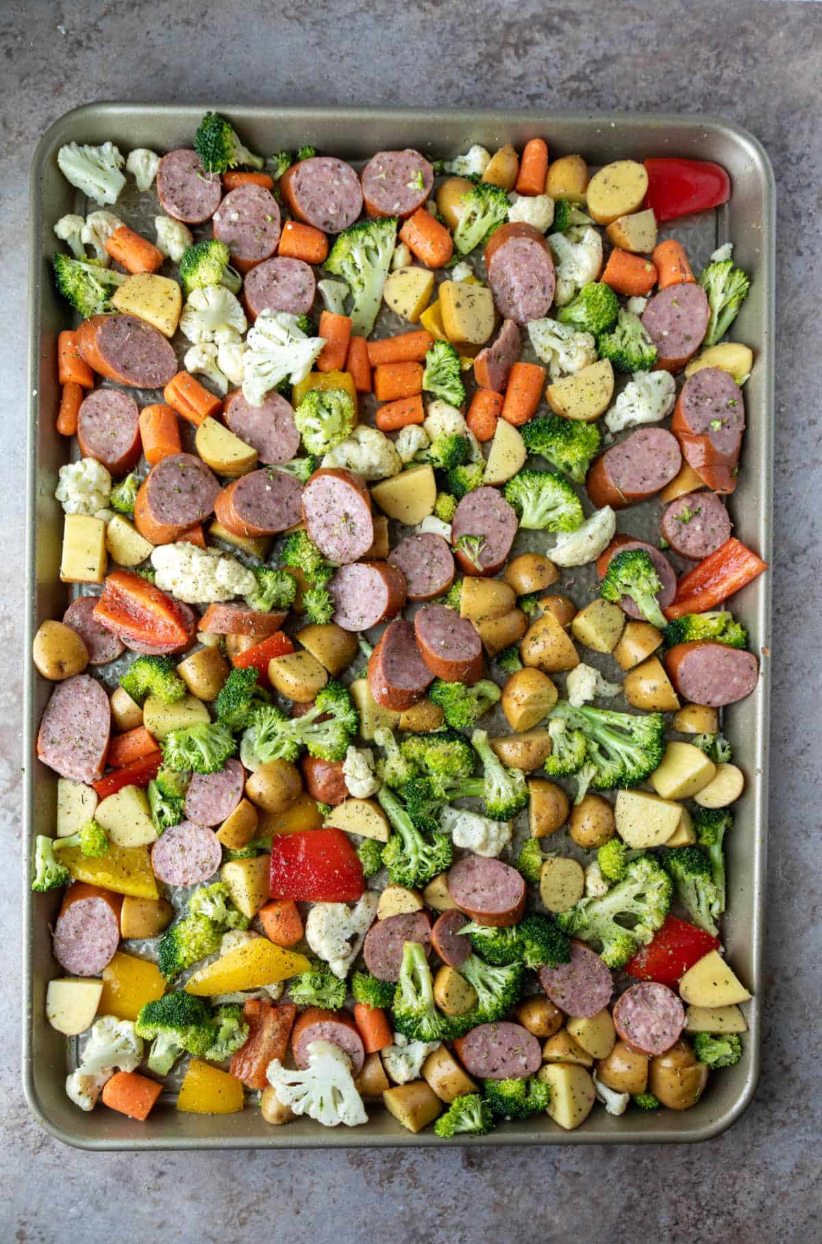 Sausage and veggies on a sheet pan.
