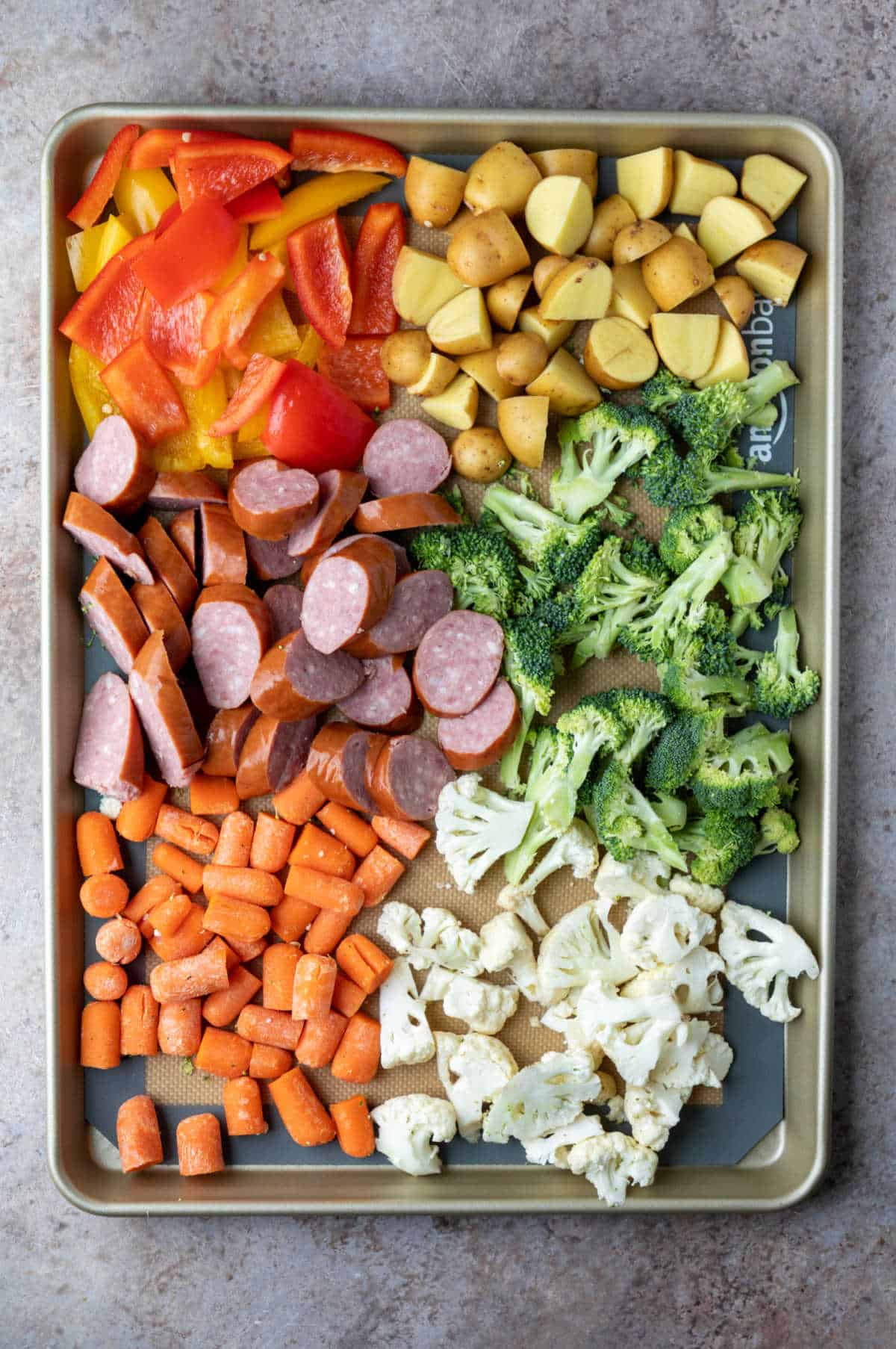 Veggies and sausage on a sheet pan.