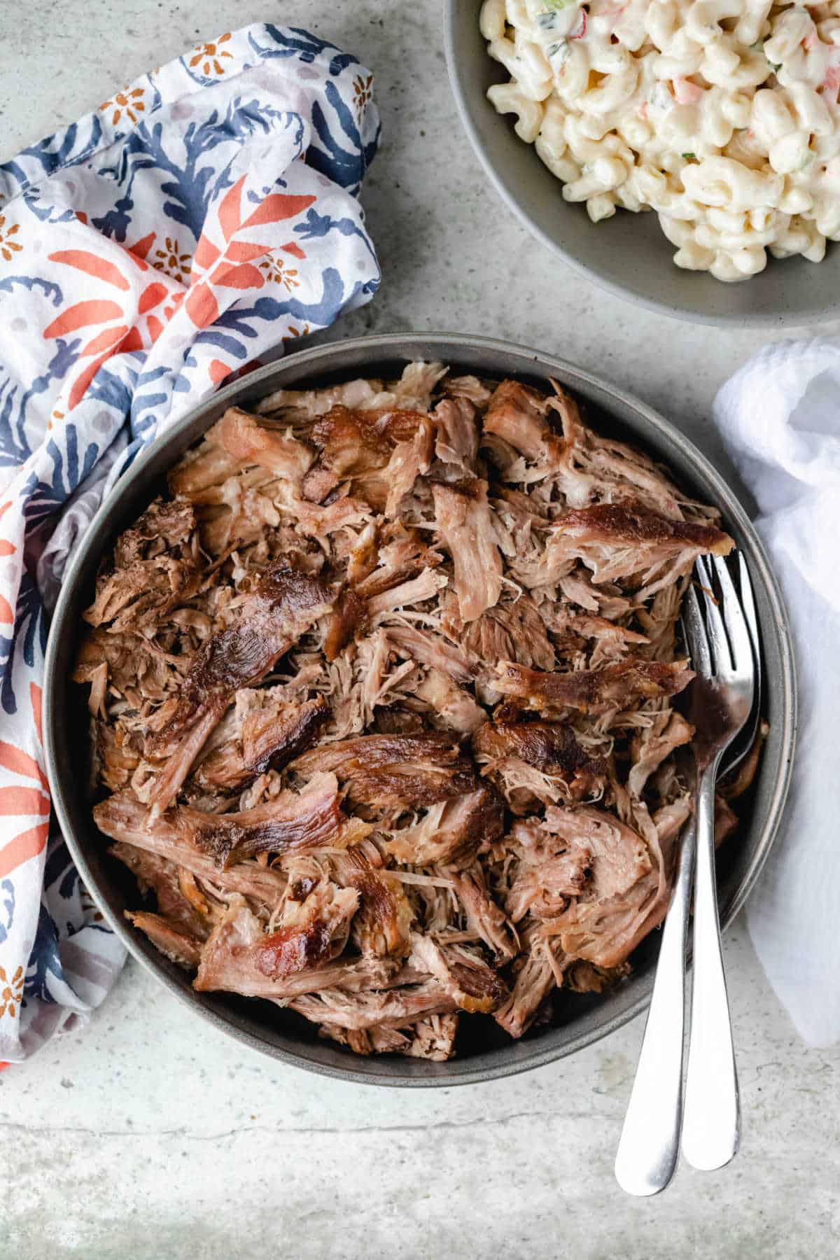 Bowl of slow cooker kalua pork with two forks in it.