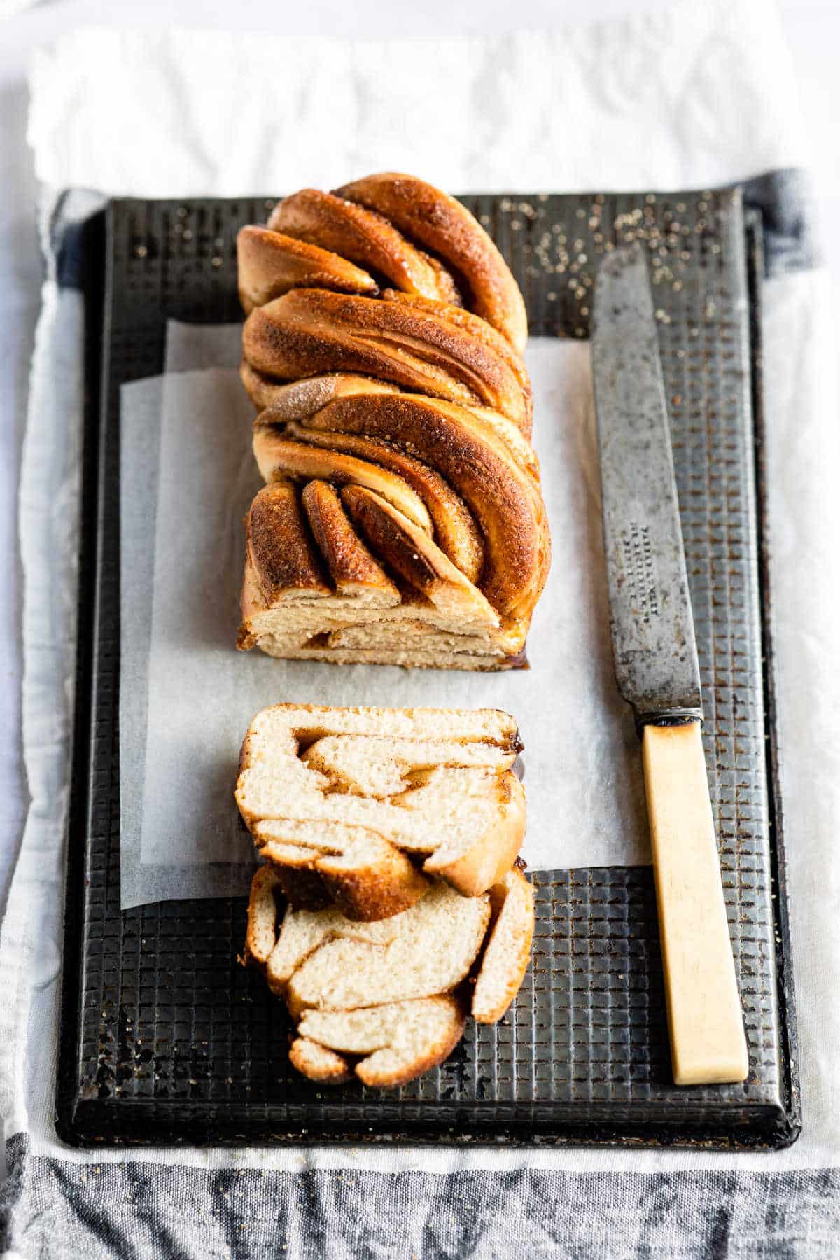 Cinnamon Twist Bread Recipe Loaf of cinnamon twist bread with two slices cut from it.