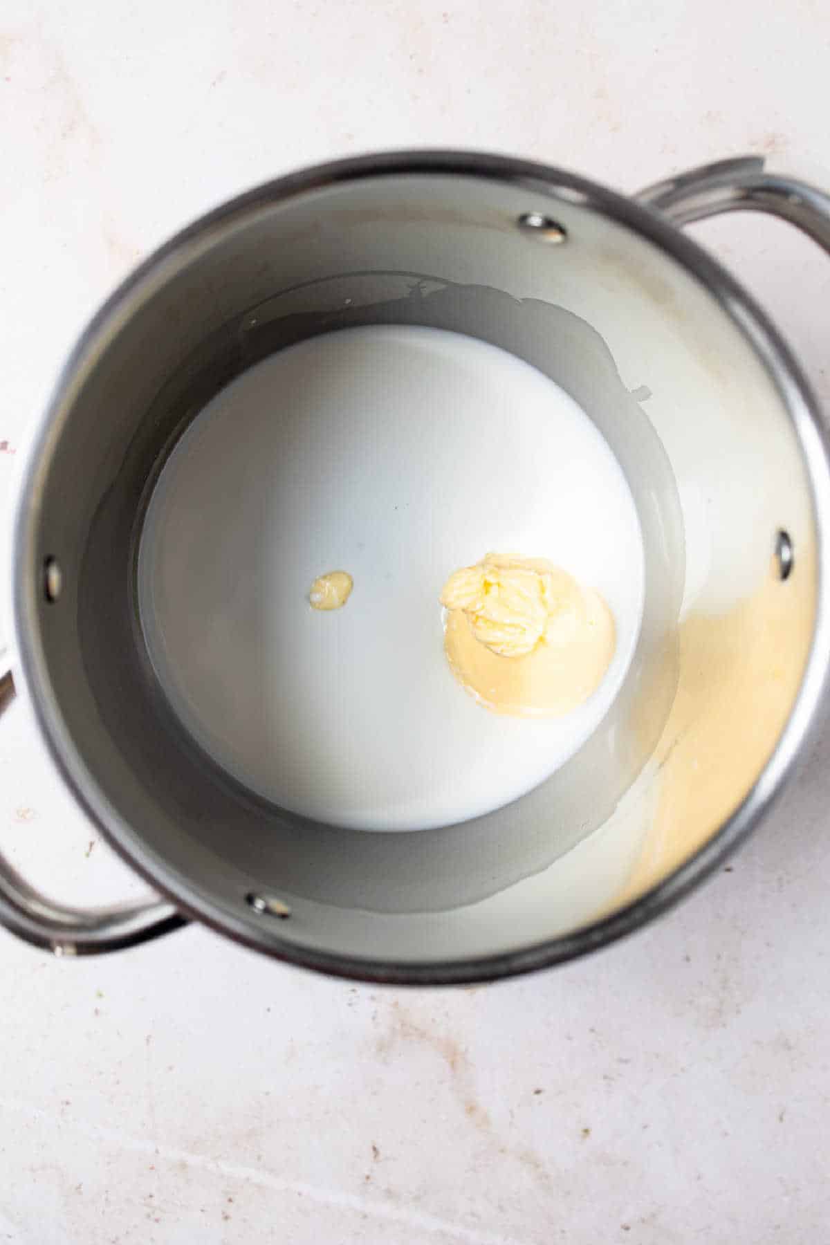 Butter and milk in a saucepan.