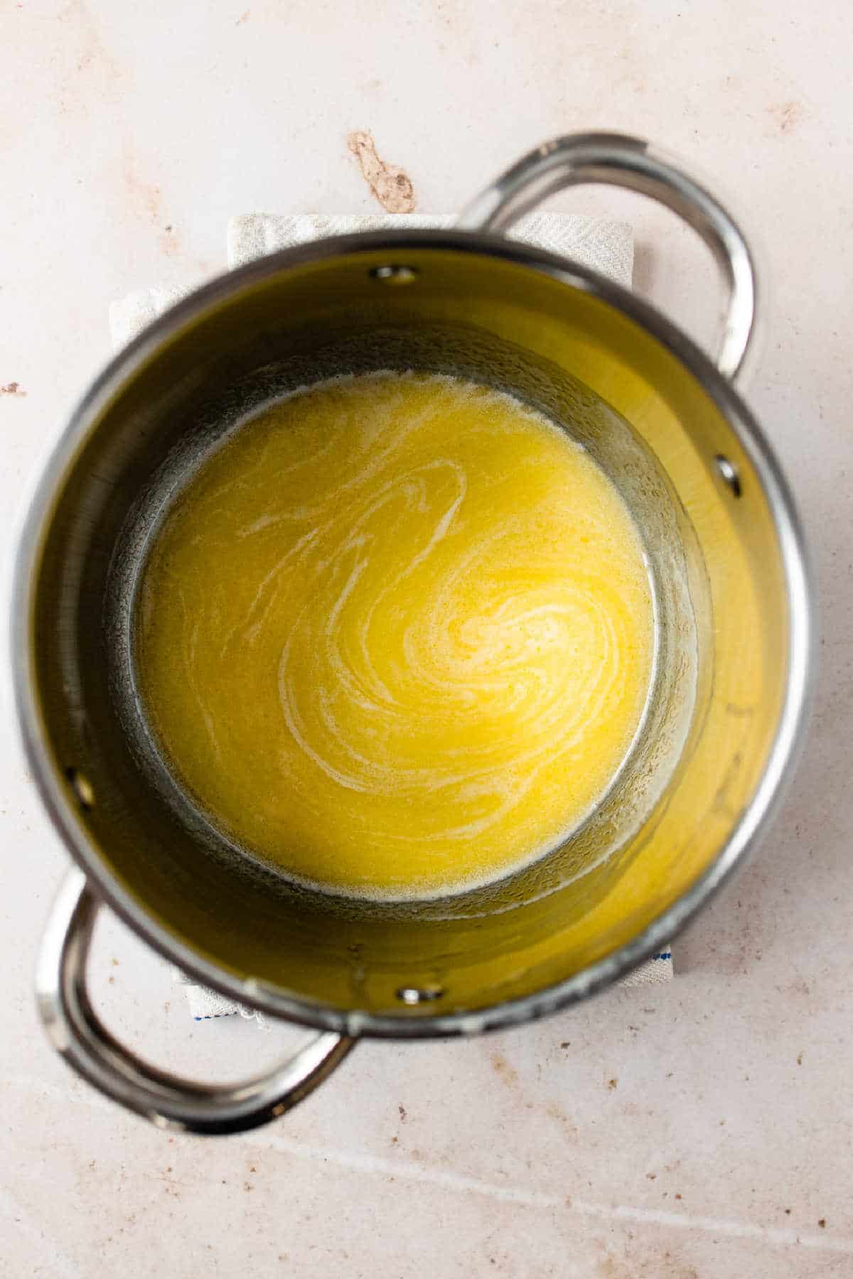 Melted butter and warm milk in a saucepan.