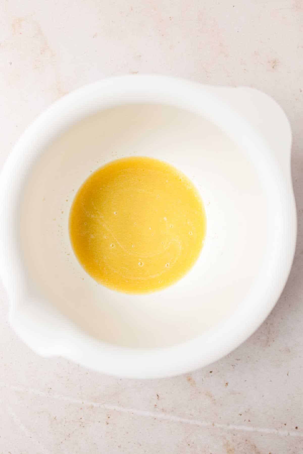 Melted butter and milk in a large mixing bowl.