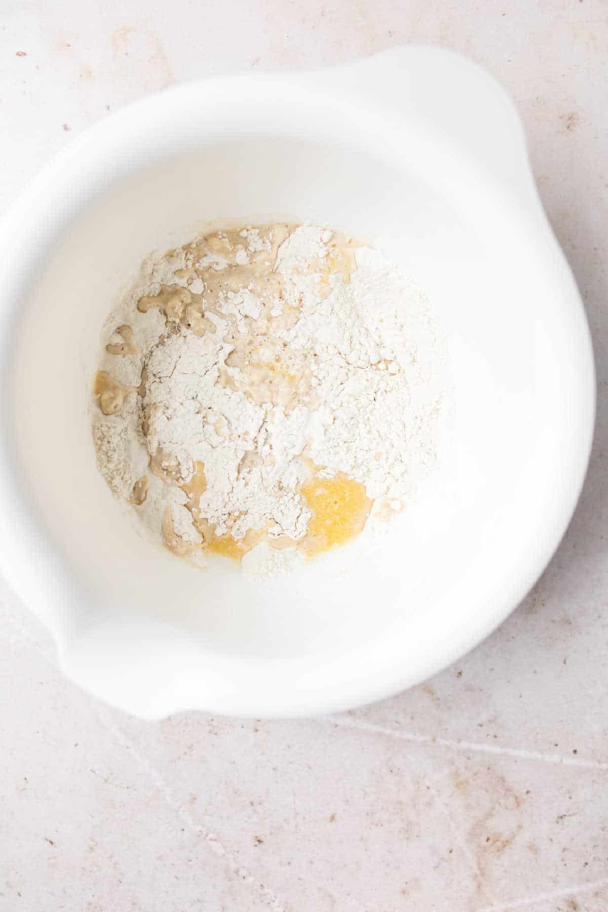 Flour milk mixture and yeast in a large mixing bowl. 