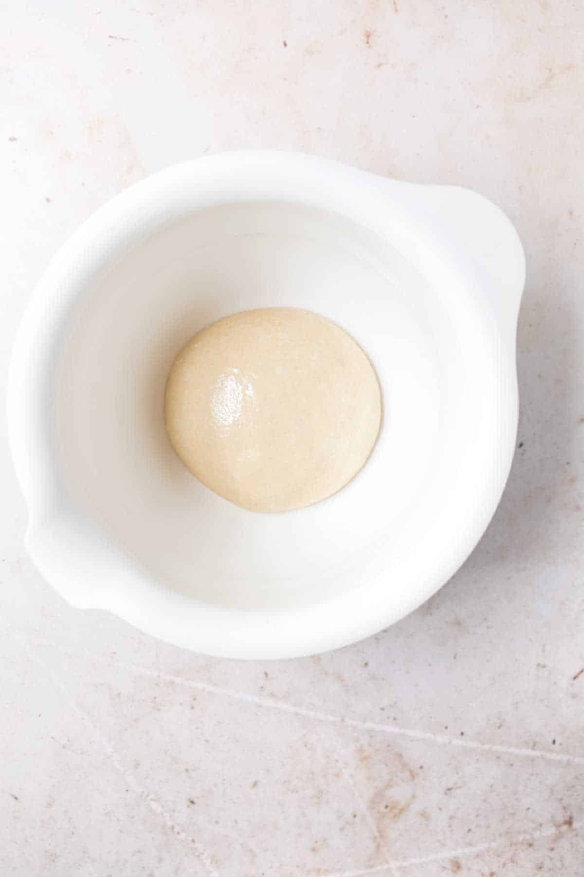 Cinnamon twist dough in a white mixing bowl. 