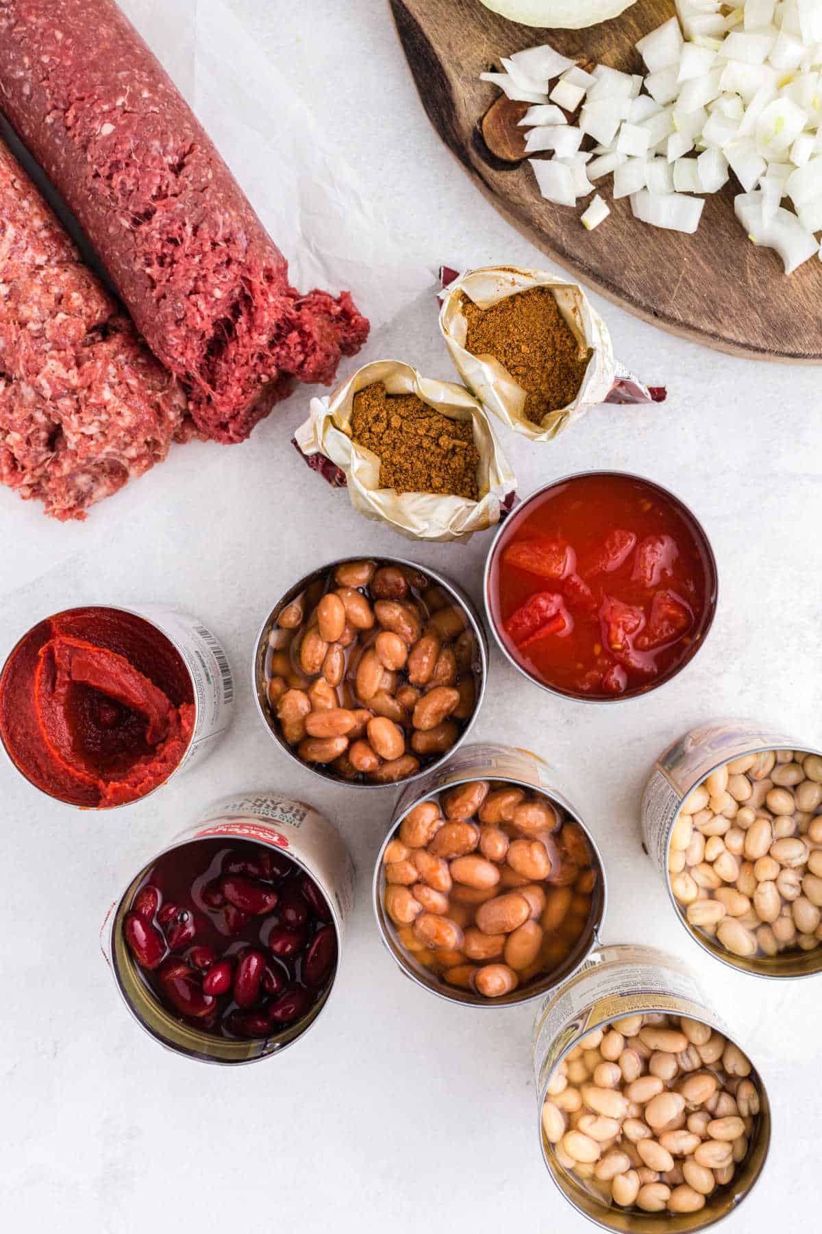 Three bean chili ingredients in cans.