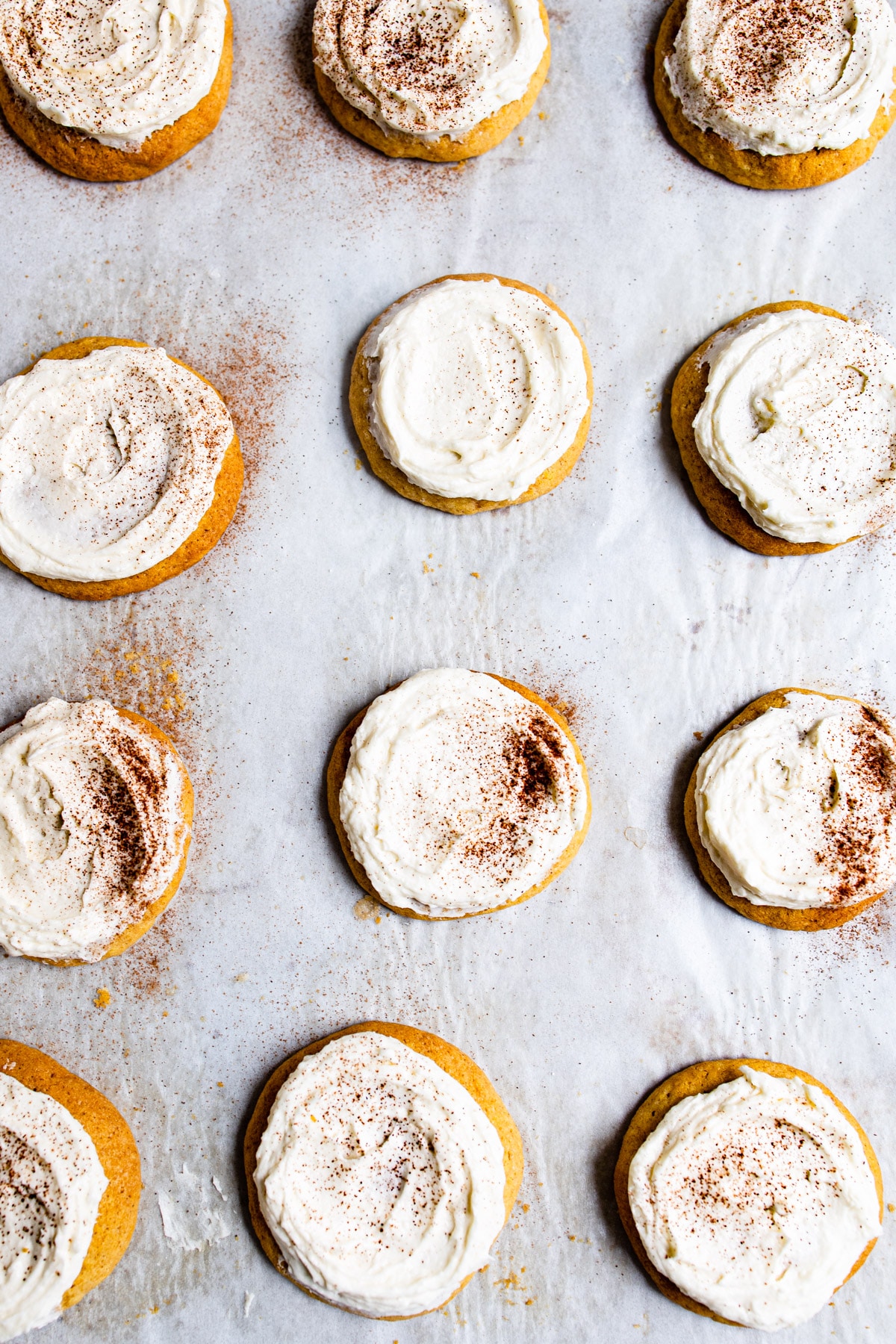 Frosted pumpkin cookies in rows.