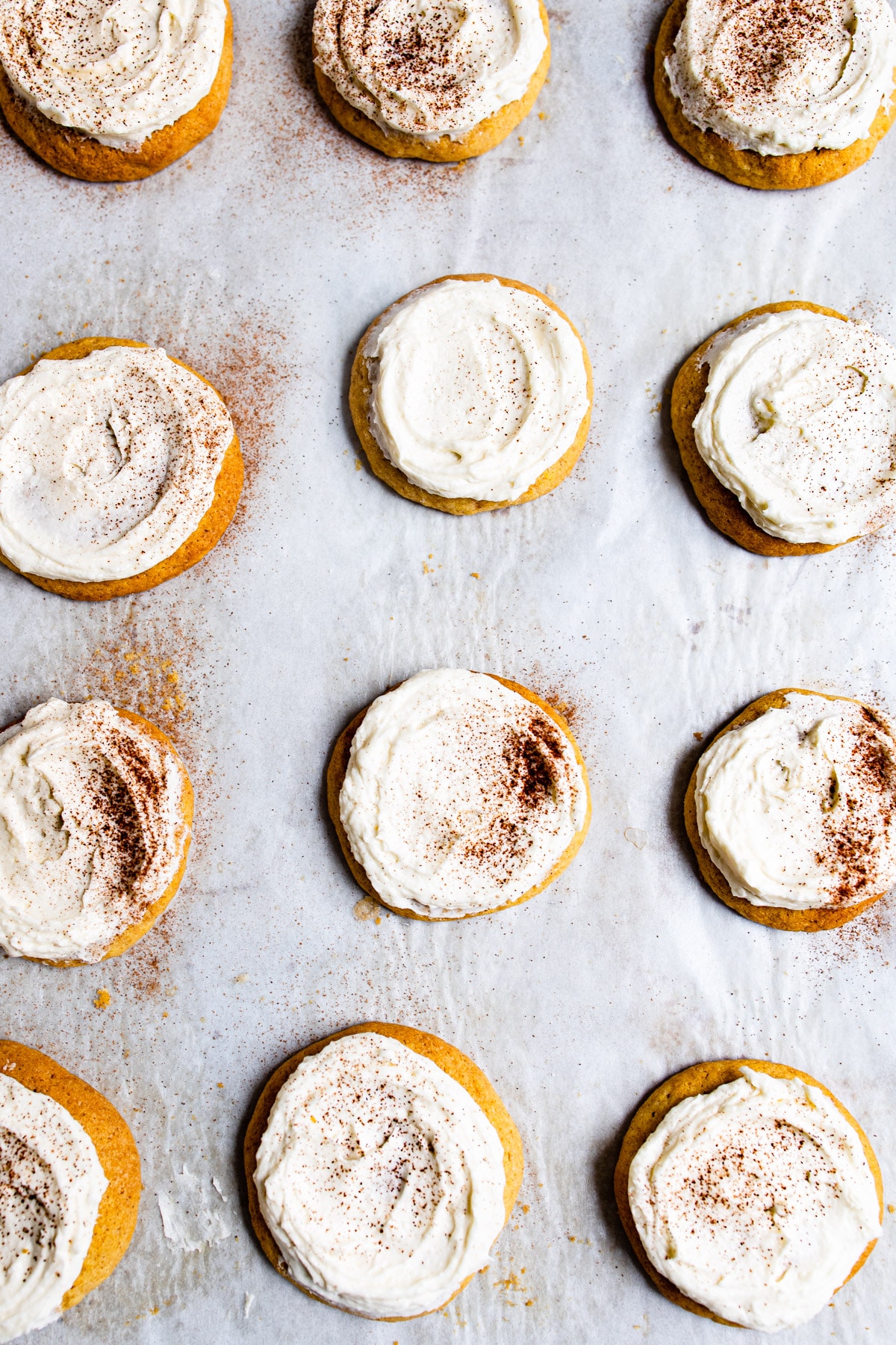 Frosted pumpkin cookies in rows. 