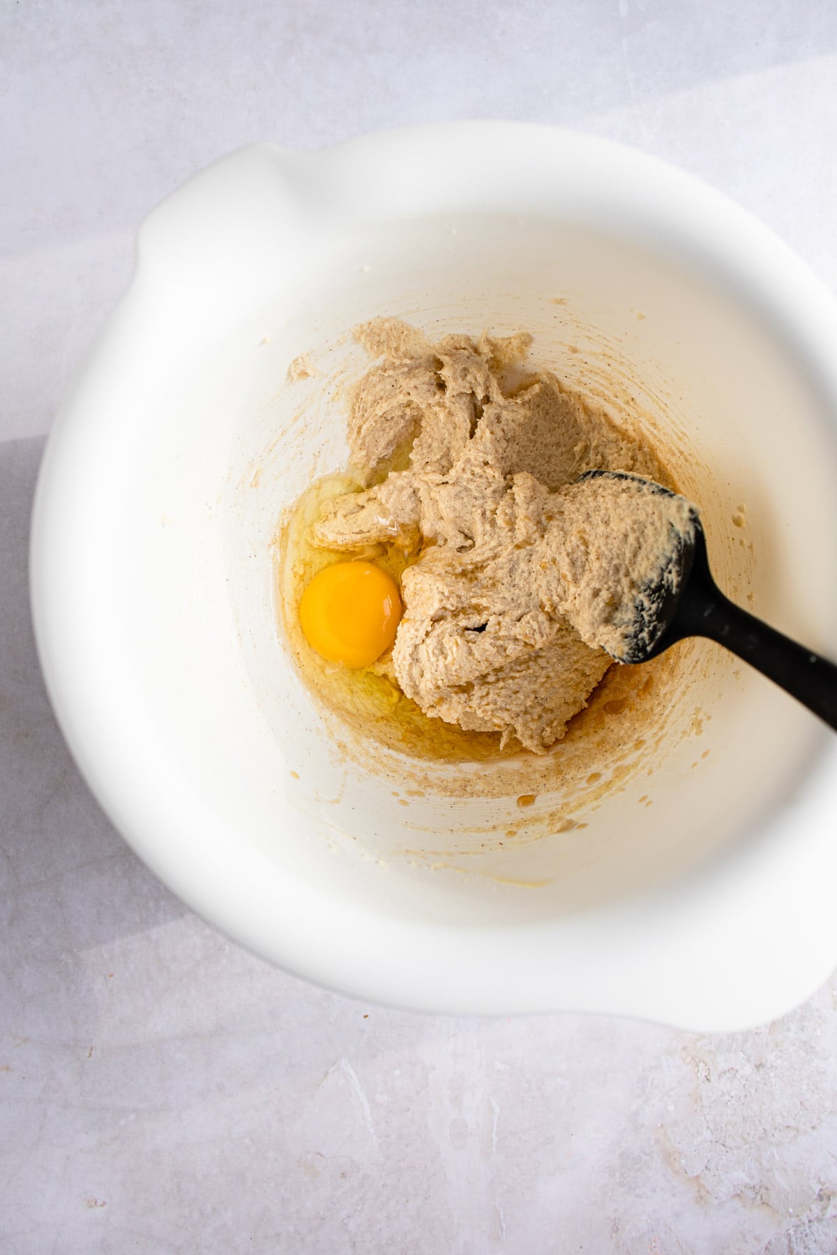 Egg and creamed butter and sugar in a mixing bowl.