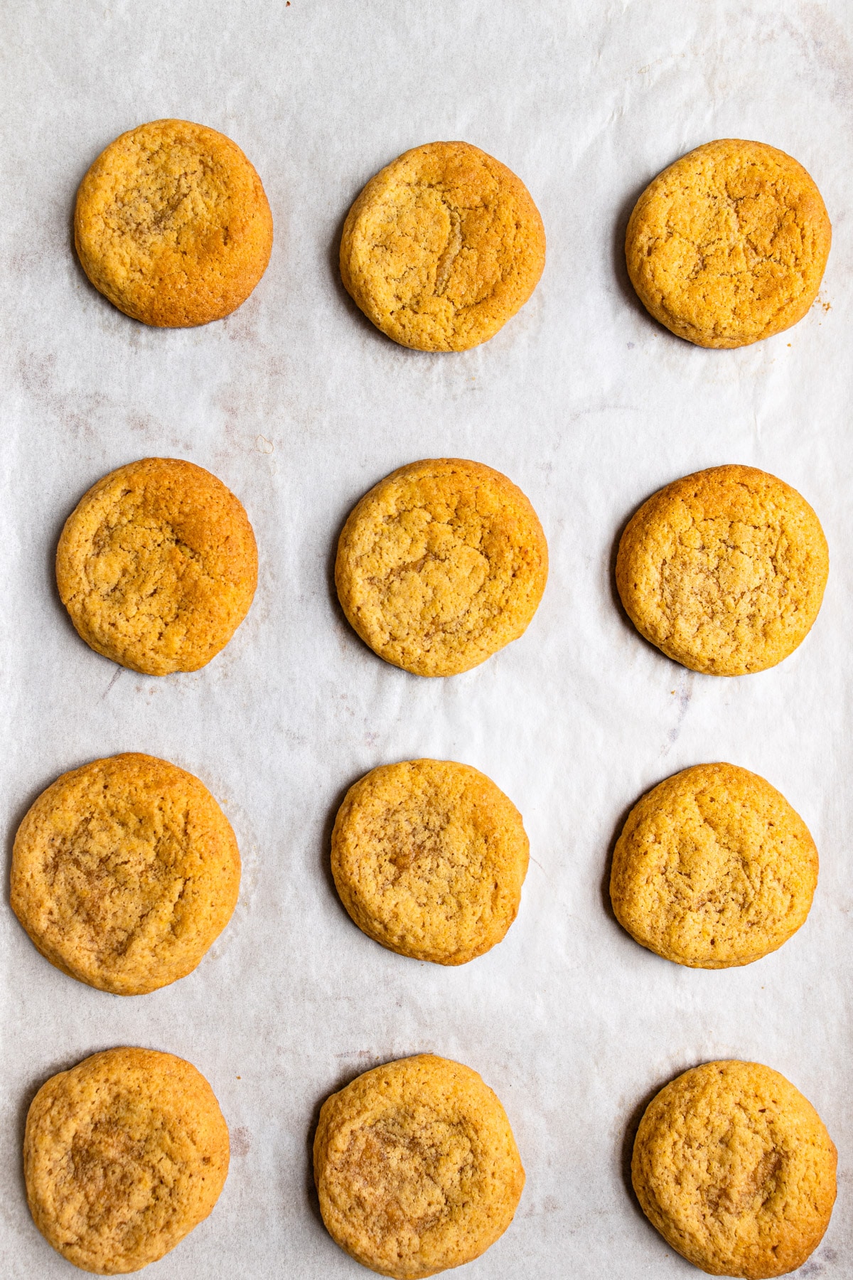 Baked pumpkin cookies on a baking sheet. 