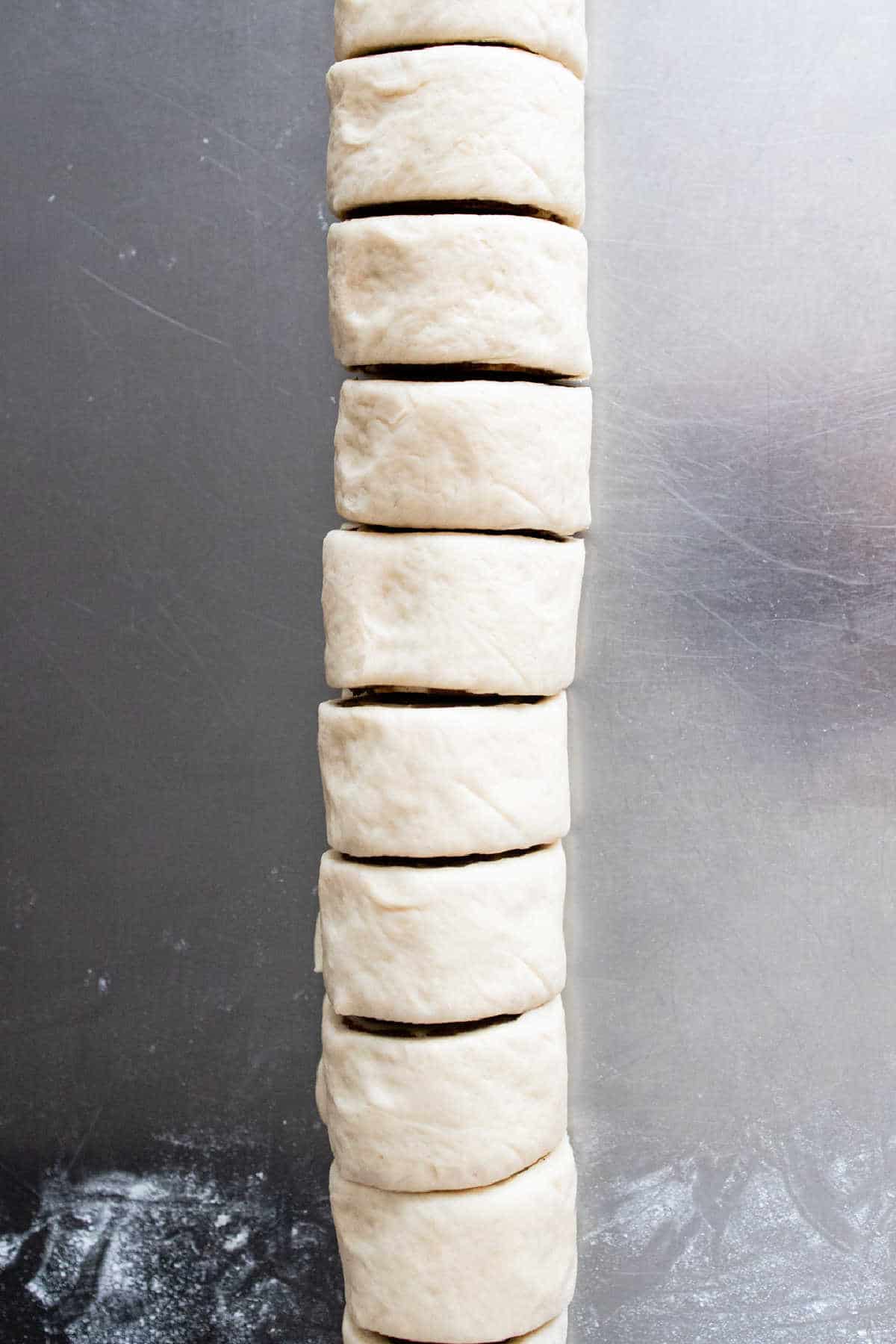 Rolled up caramel roll dough cut into pieces.