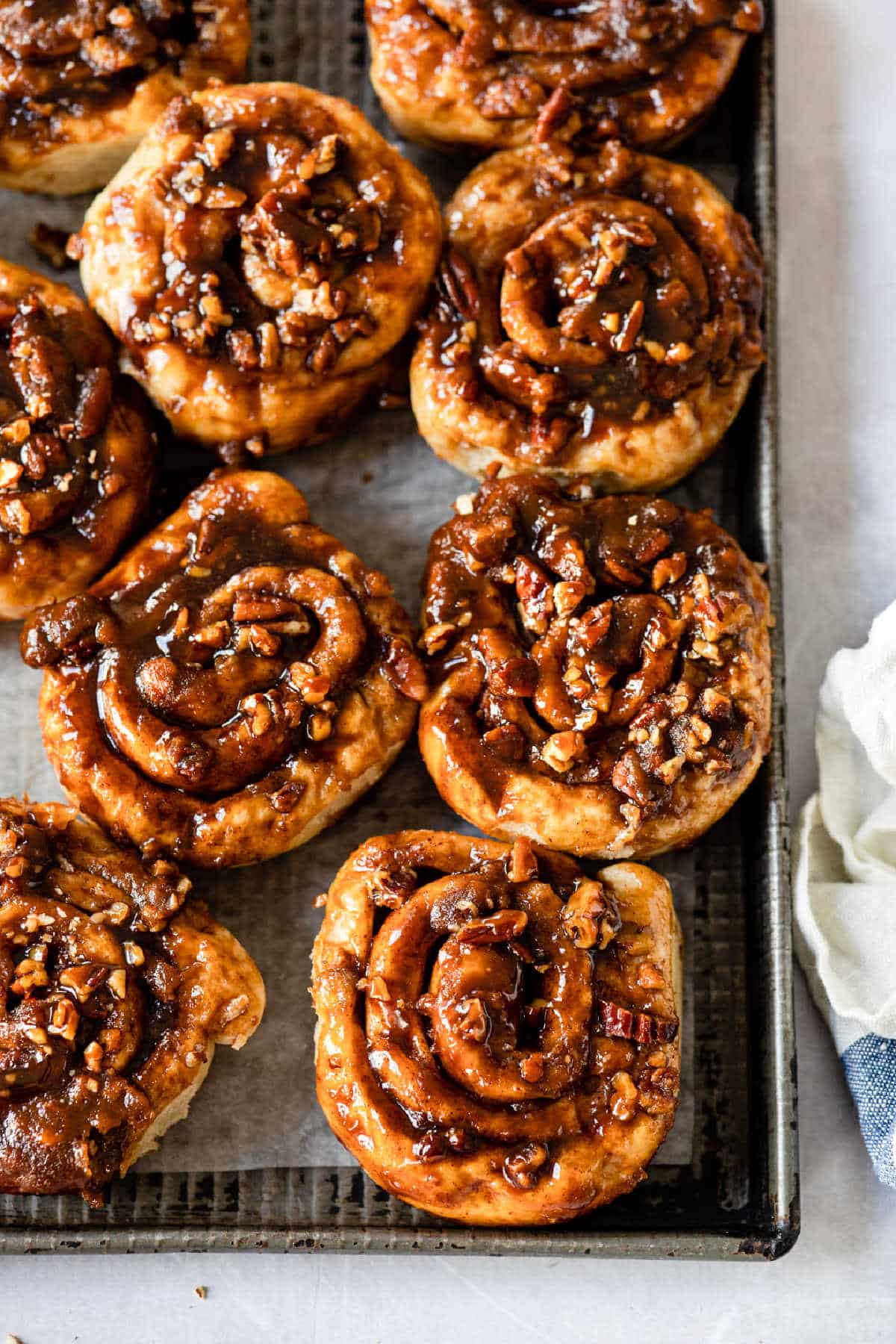 Several caramel rolls on a baking sheet. 