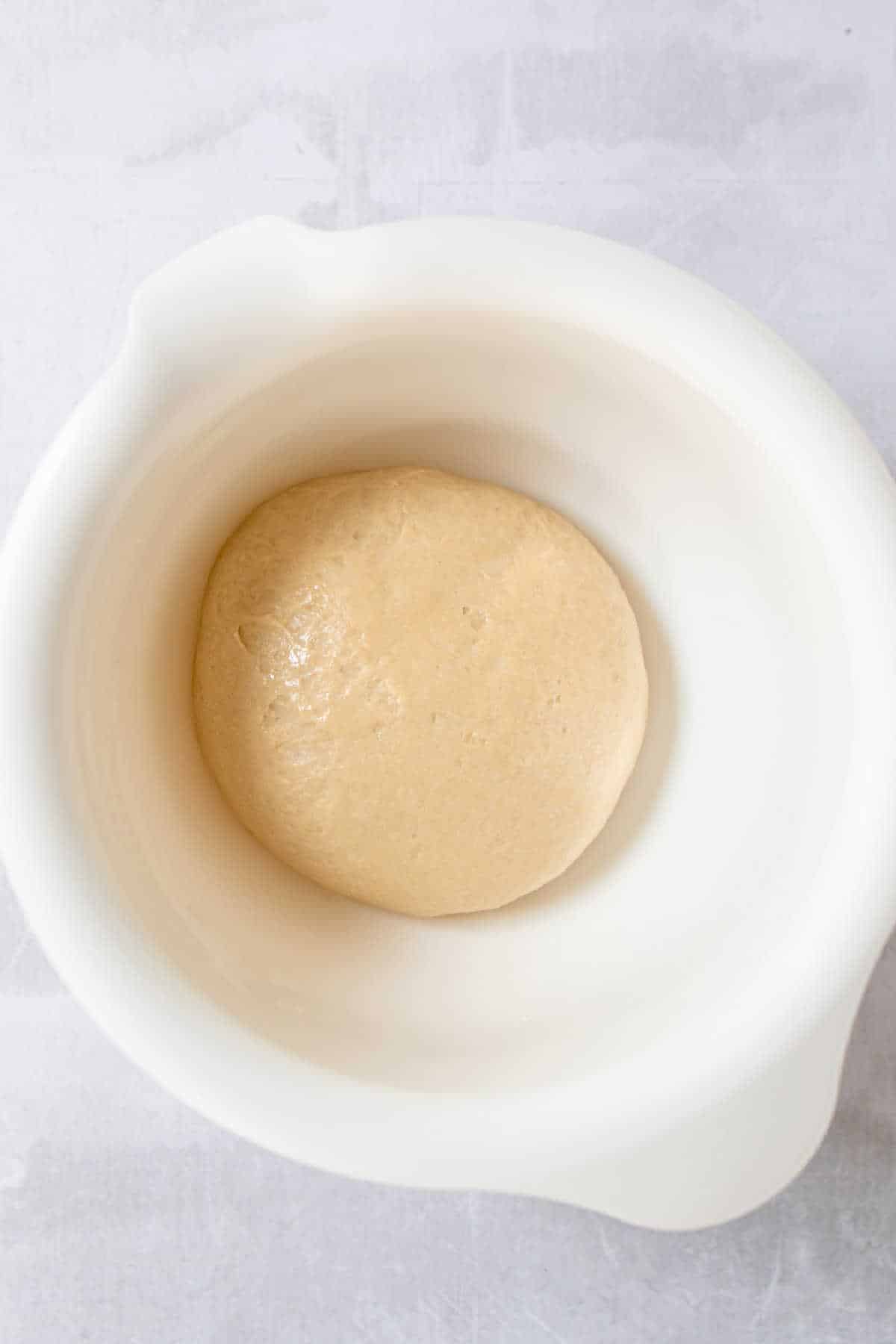 Roll dough in a mixing bowl. 