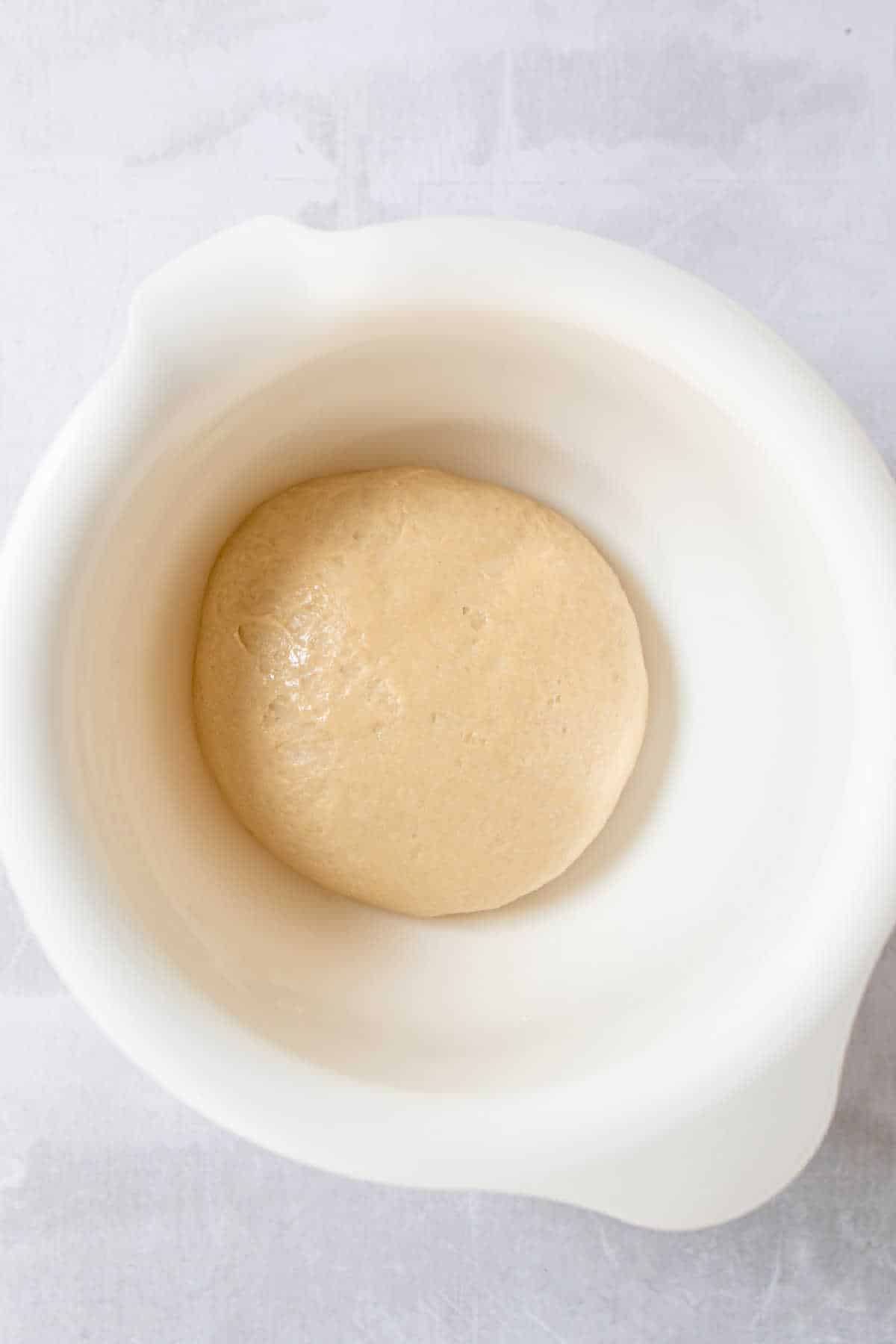 Roll dough in a mixing bowl.