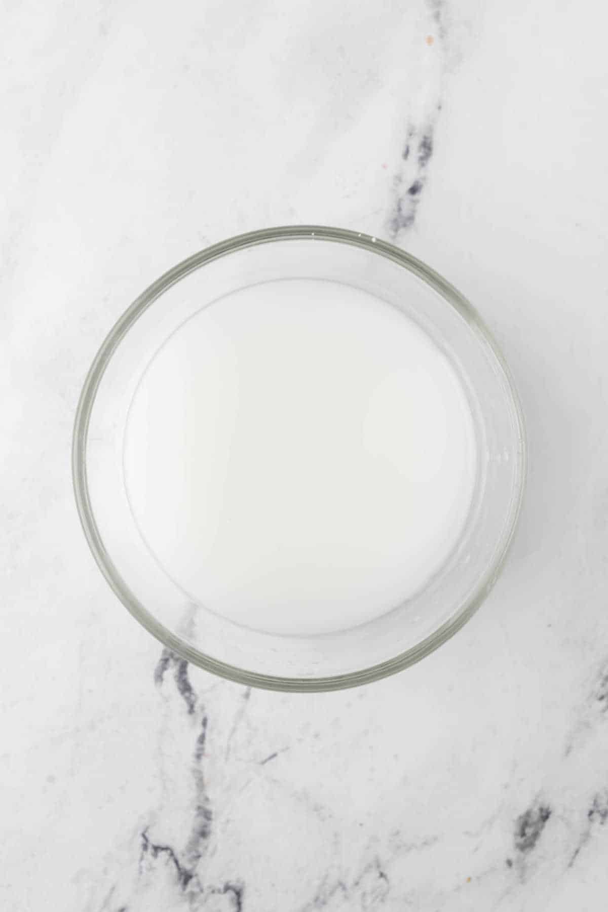 Cornstarch slurry in a glass mixing bowl.