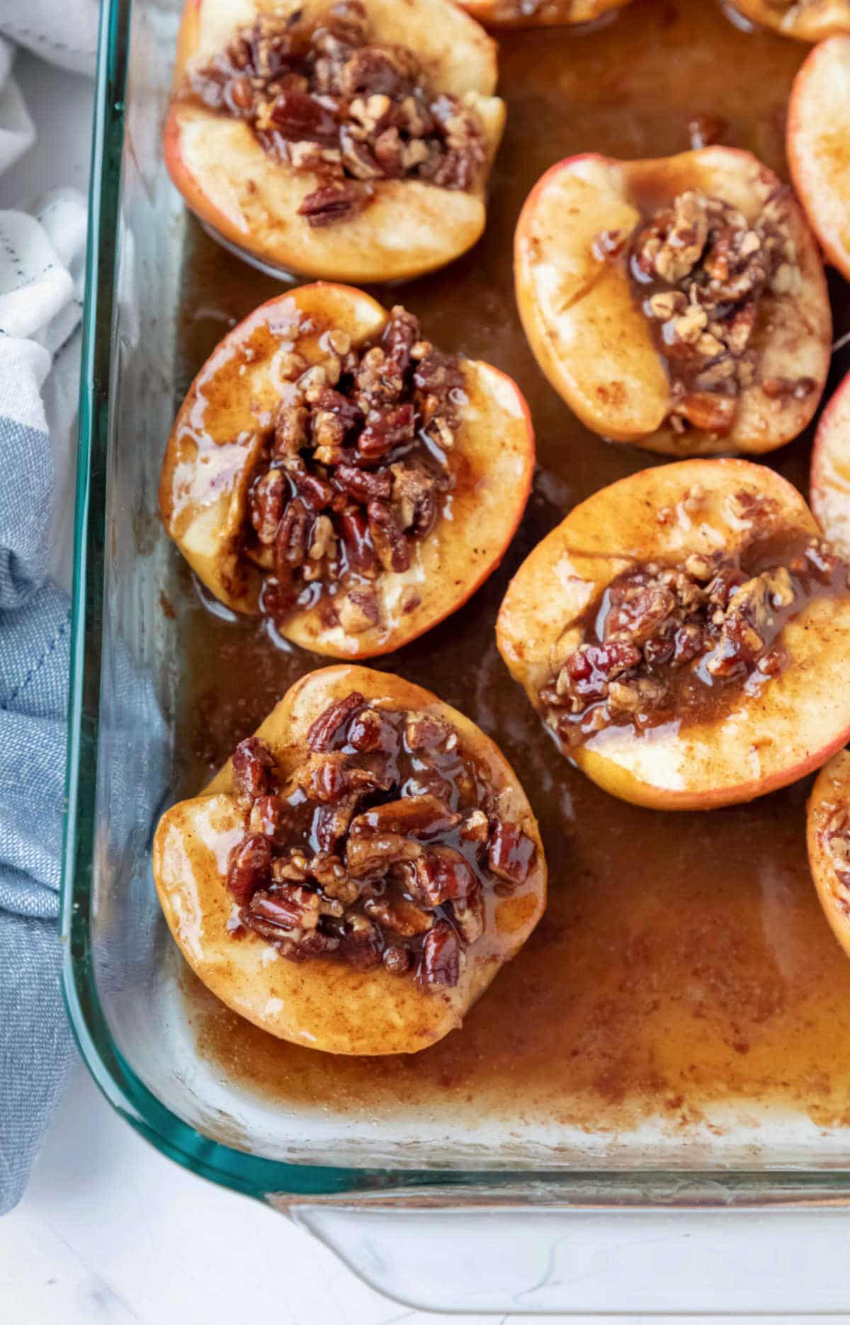 Baked apples in glass baking dish.