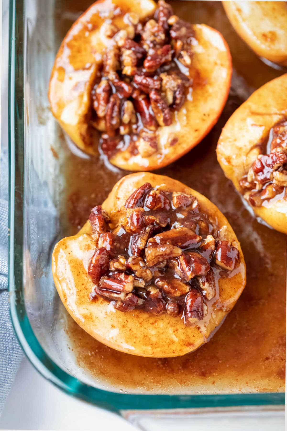 Baked apples in a glass baking dish.