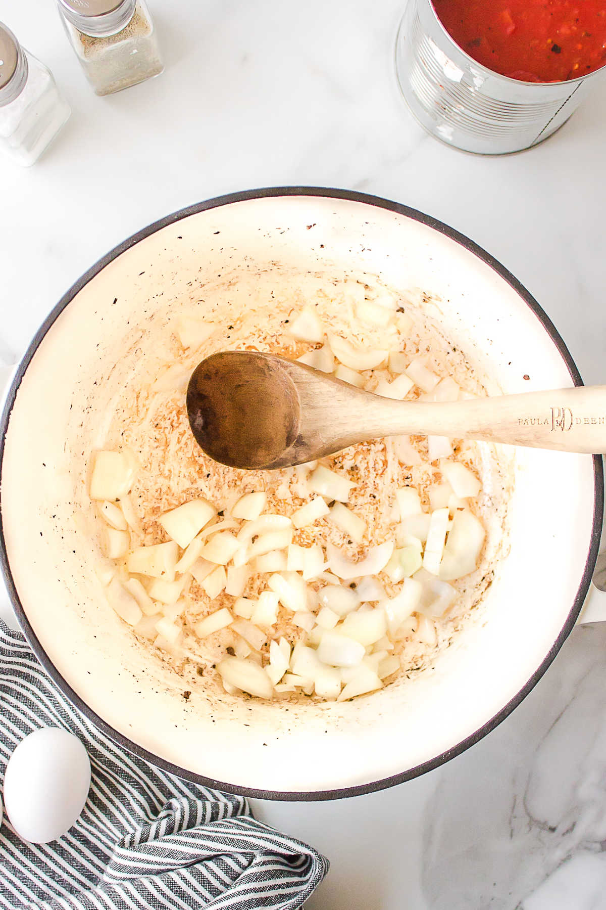 Diced onion in a white Dutch oven.