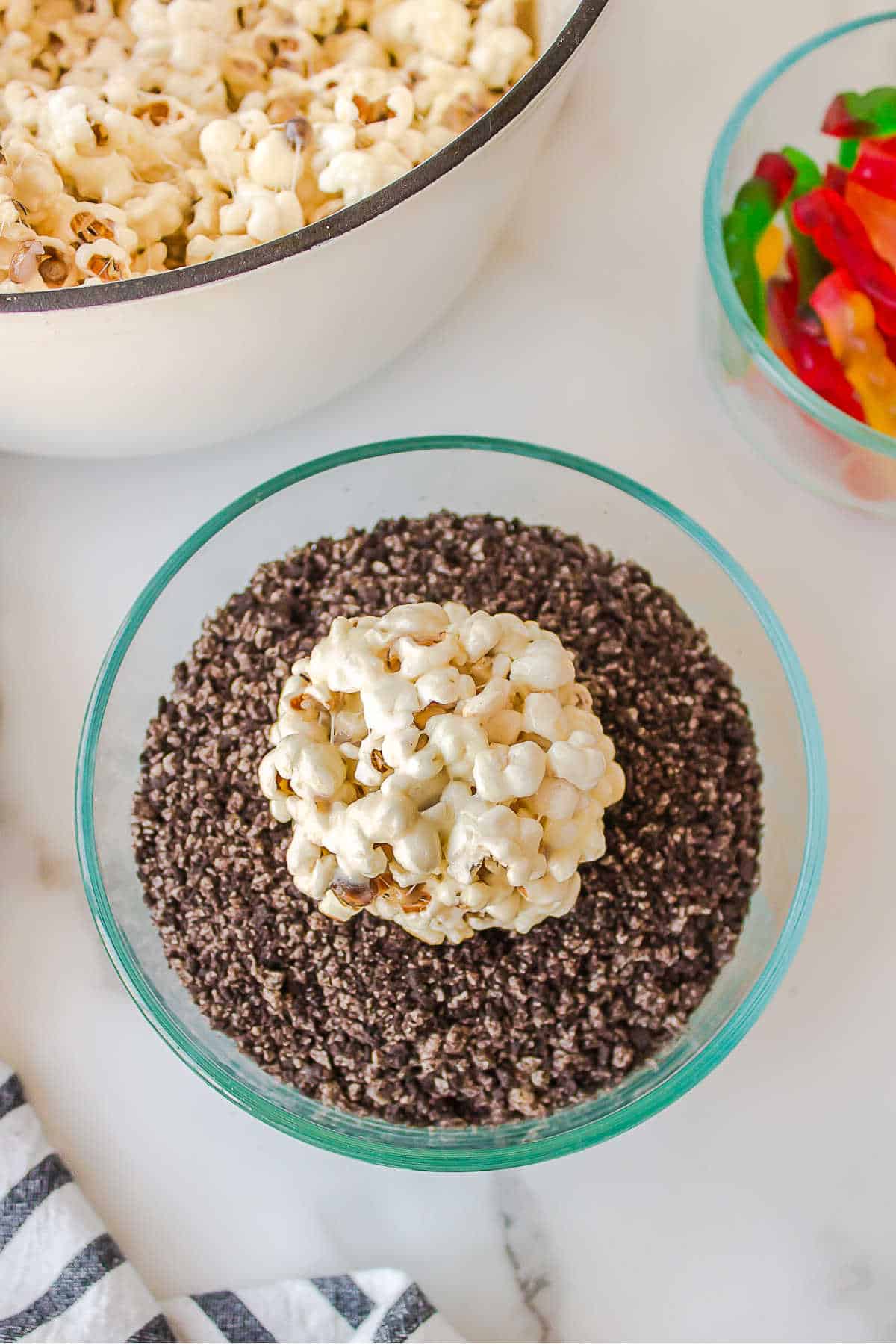 Popcorn ball in Oreo cookie crumbs.