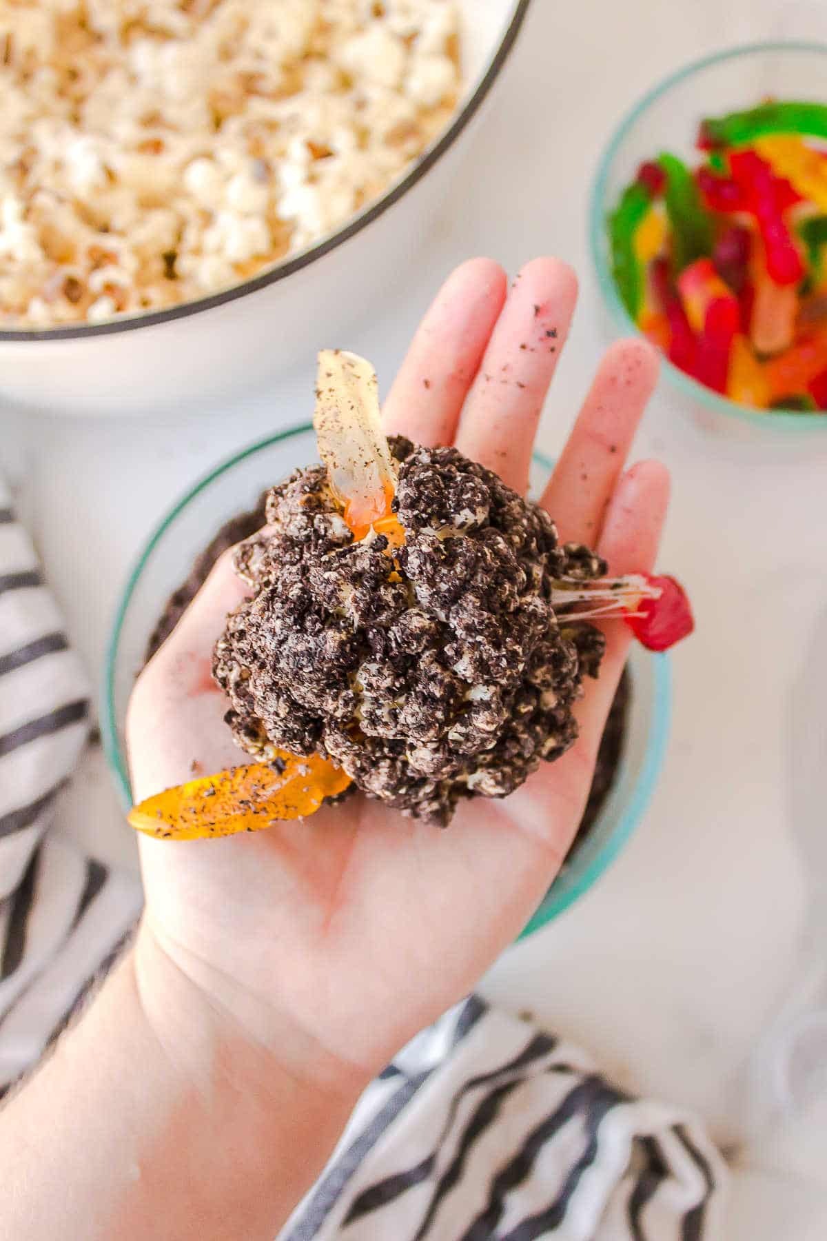 Hand holding a dirt ball.