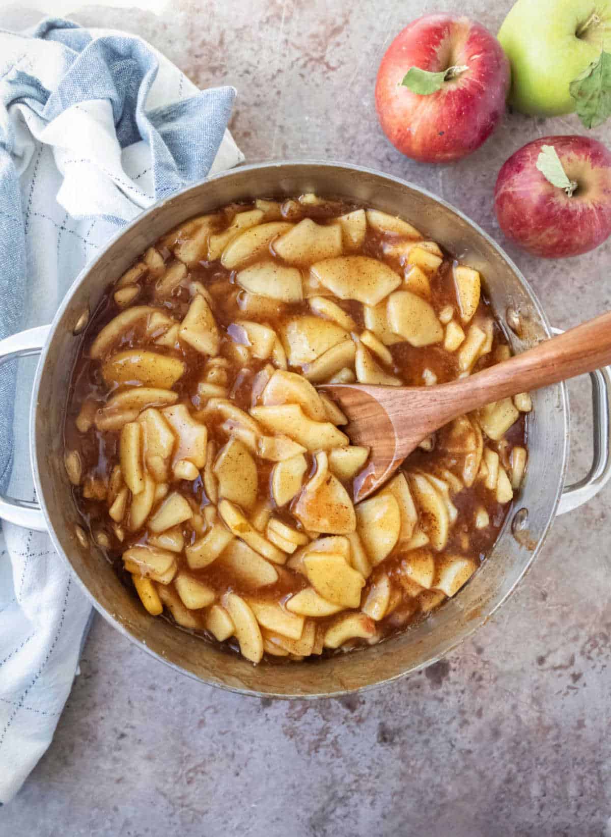 Cooked apple pie filling in a saucepot. 