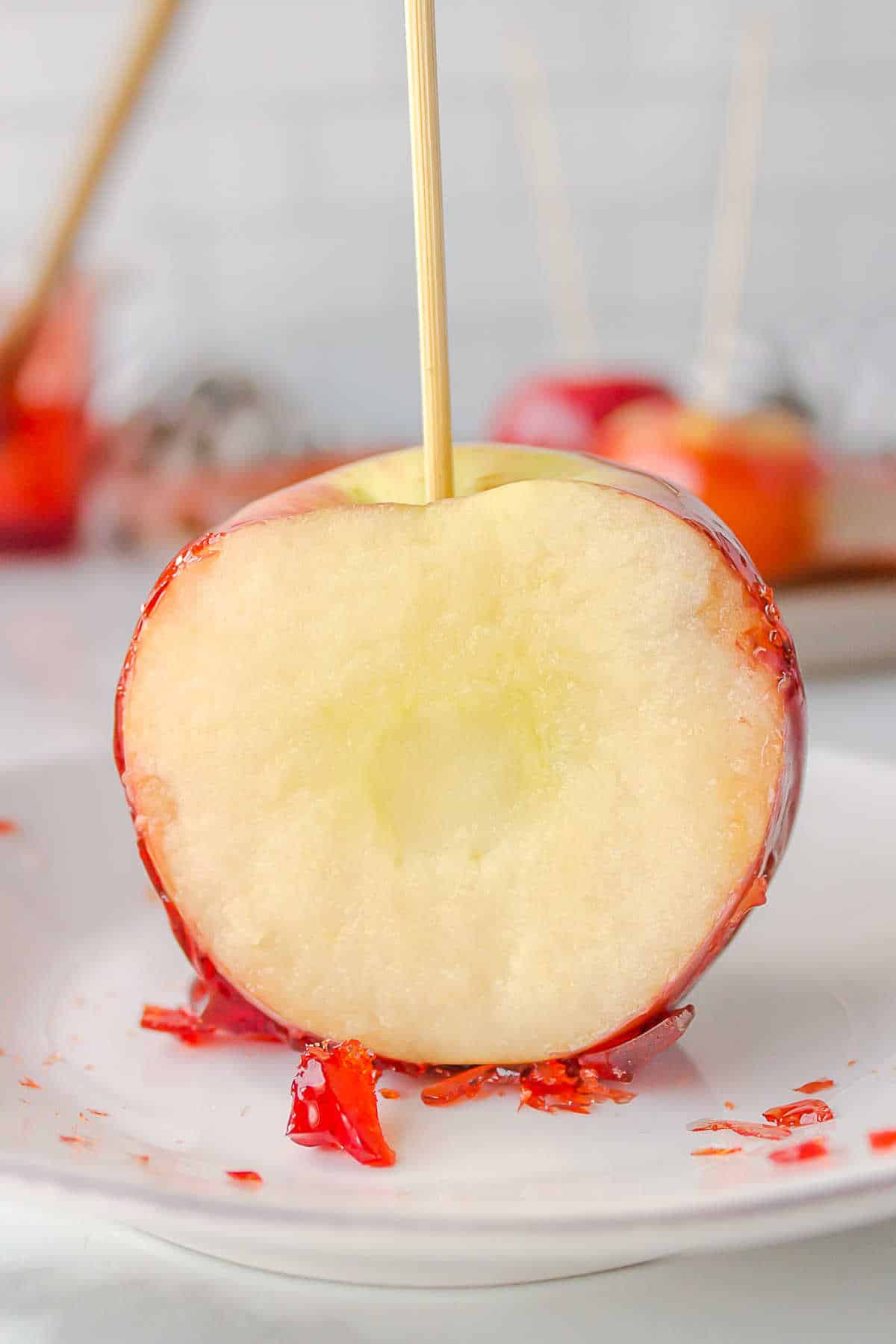 Candy apple with a slice missing.