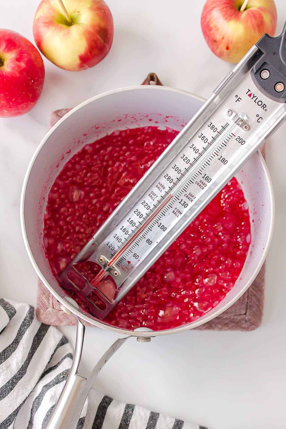 Candy thermometer in a pan of boiling candy mixture. 