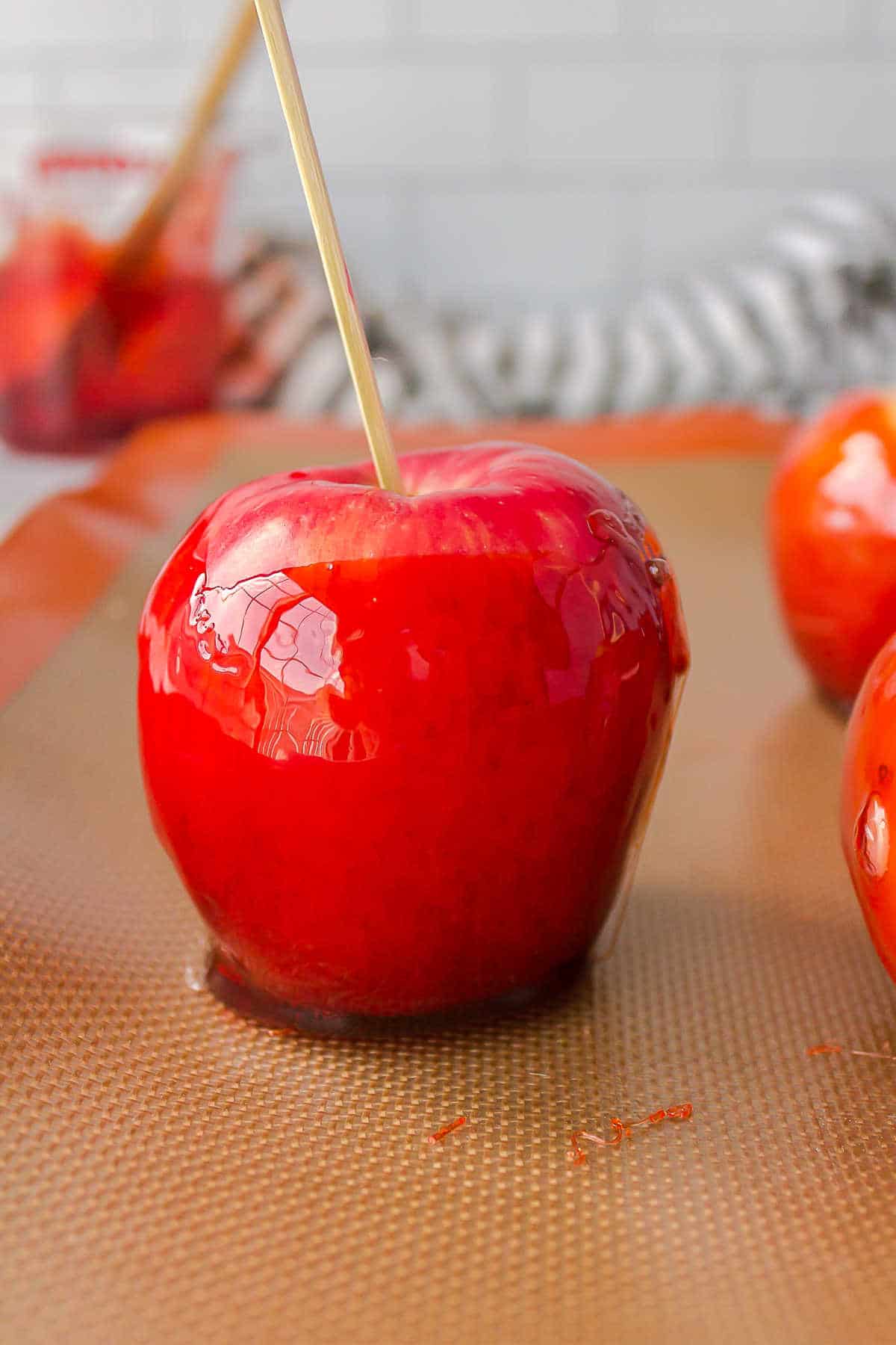 Candy apple on a silicone baking mat. 