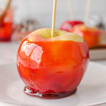 Candy apple on a white plate.