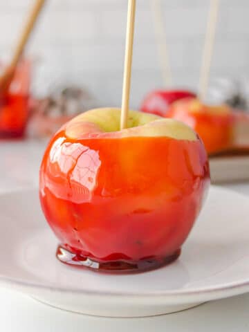 Candy apple on a white plate.
