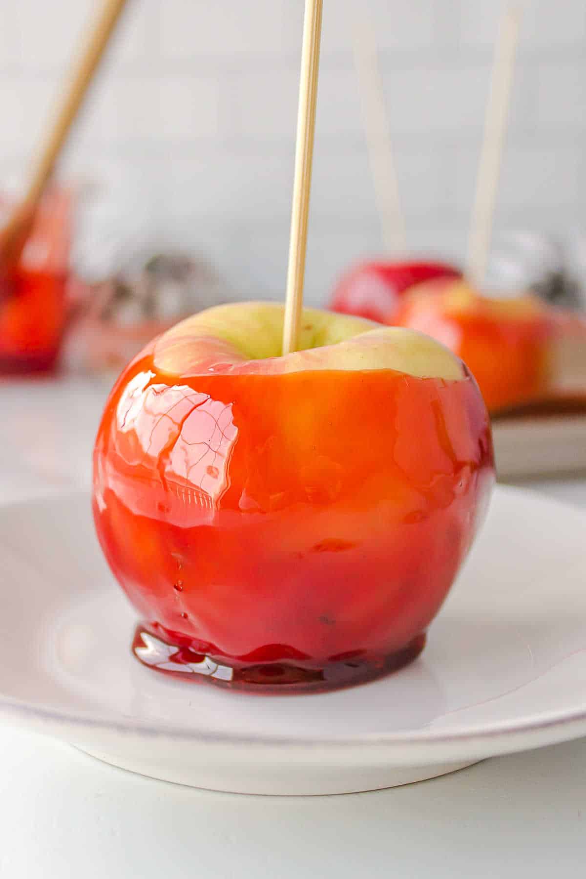 Candy apple on a white plate.